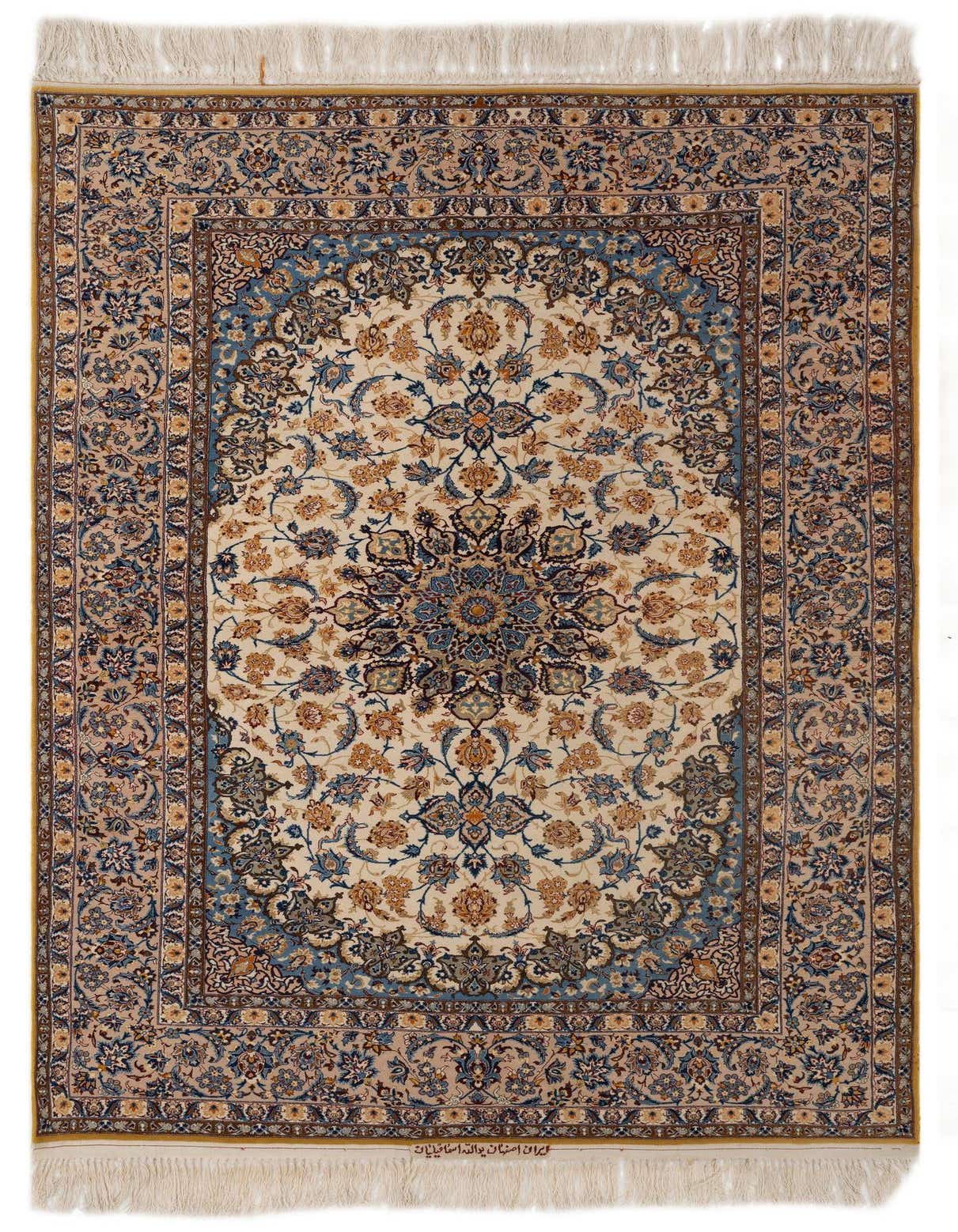 A rectangular 5x8 Isfahan Persian rug featuring a detailed ivory and tan floral medallion on a cream field, with a blue and brown border, showcasing its intricate handmade design.
