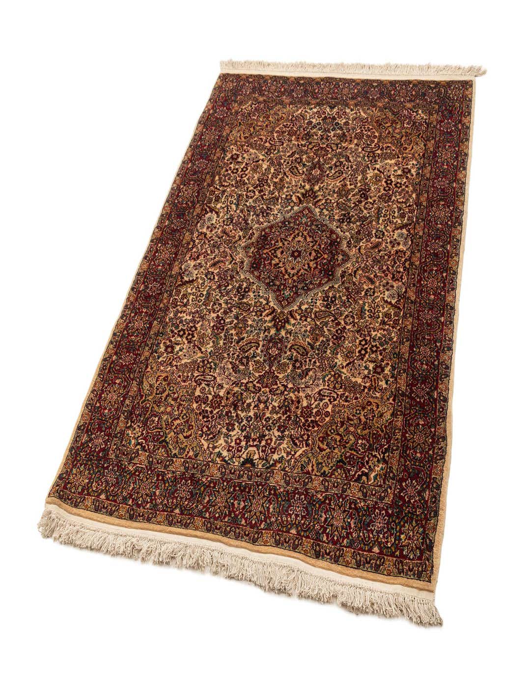 A 4x6 rectangular Kashmir wool rug with a detailed traditional pattern in browns, tans, and ivories, featuring a central medallion.