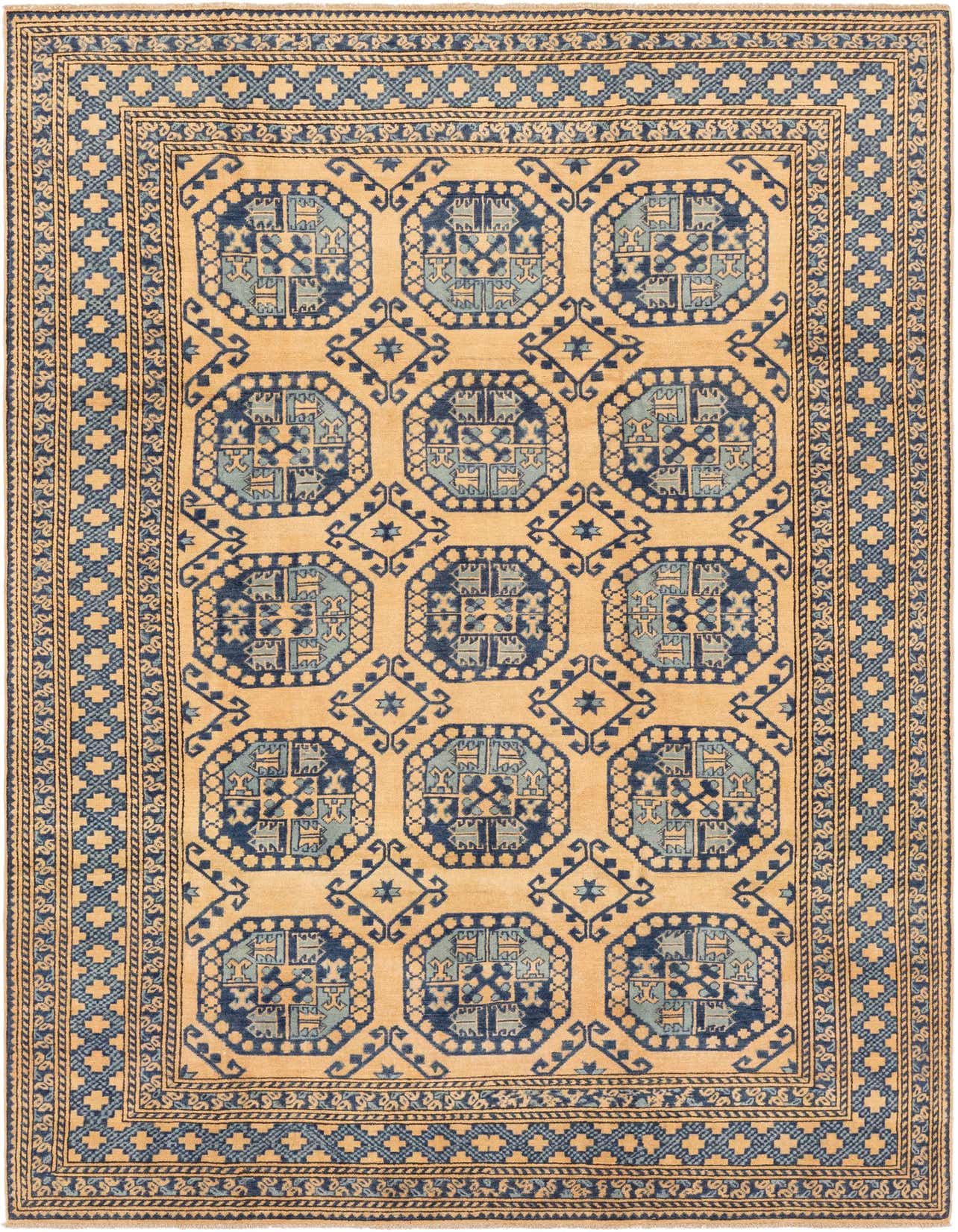A rectangular 6x9 Kazak rug in tan and blue, featuring traditional Southwestern tribal patterns with geometric medallions and a detailed border.