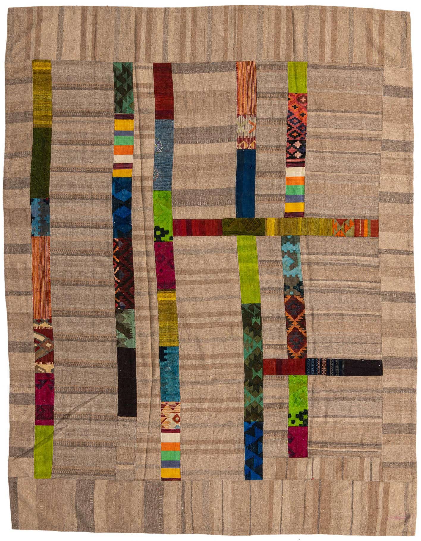 A 7x10 rectangular flatweave rug featuring a tan and brown striped background with colorful vertical and horizontal patchwork strips in tribal patterns.