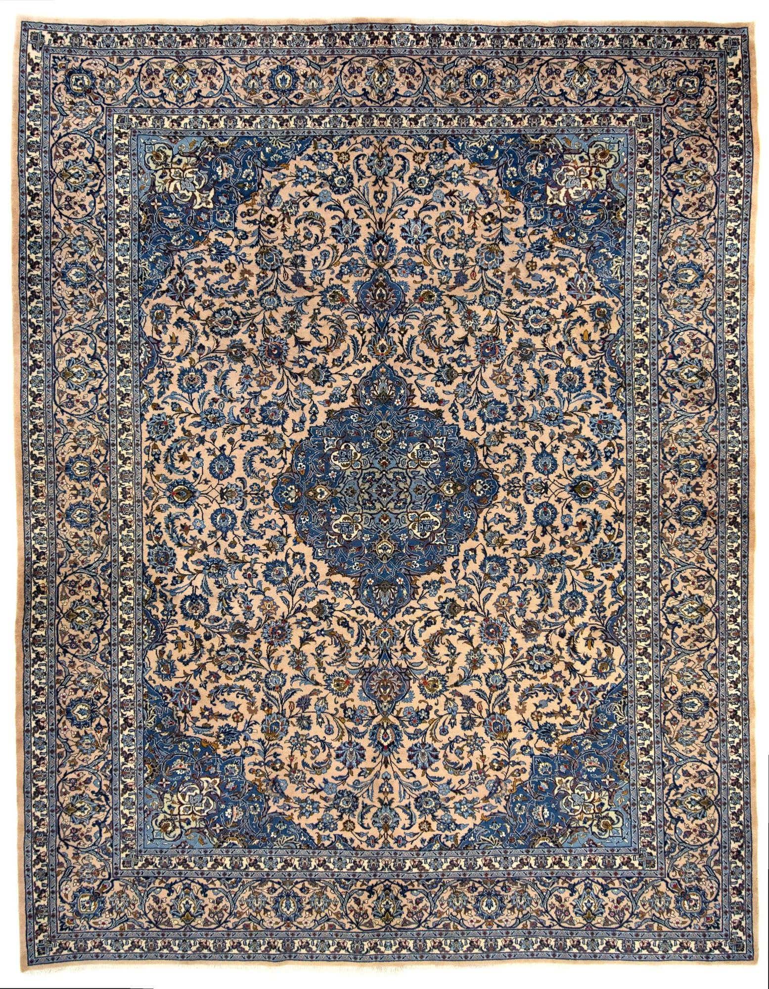 A 10x12 rectangular Mashad Persian rug with a cream and tan background, featuring intricate blue and brown floral patterns and a central medallion.