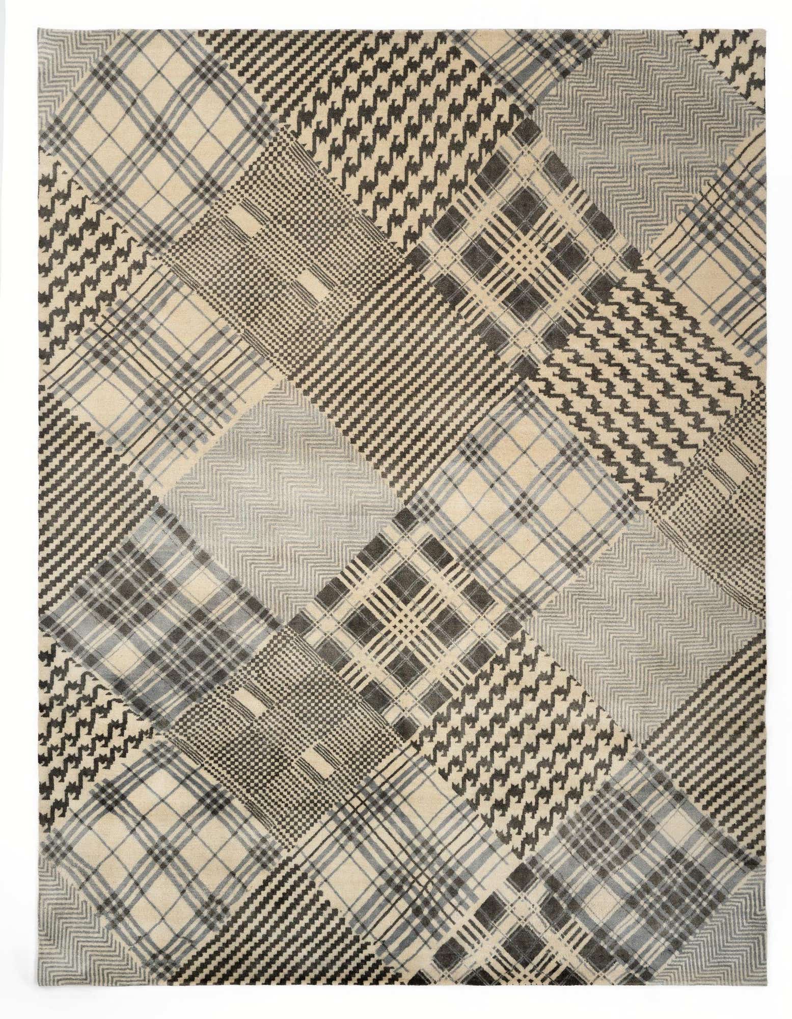 A rectangular 8x10 wool rug featuring a modern patchwork of plaid, houndstooth, and striped patterns in shades of brown, tan, and ivory.