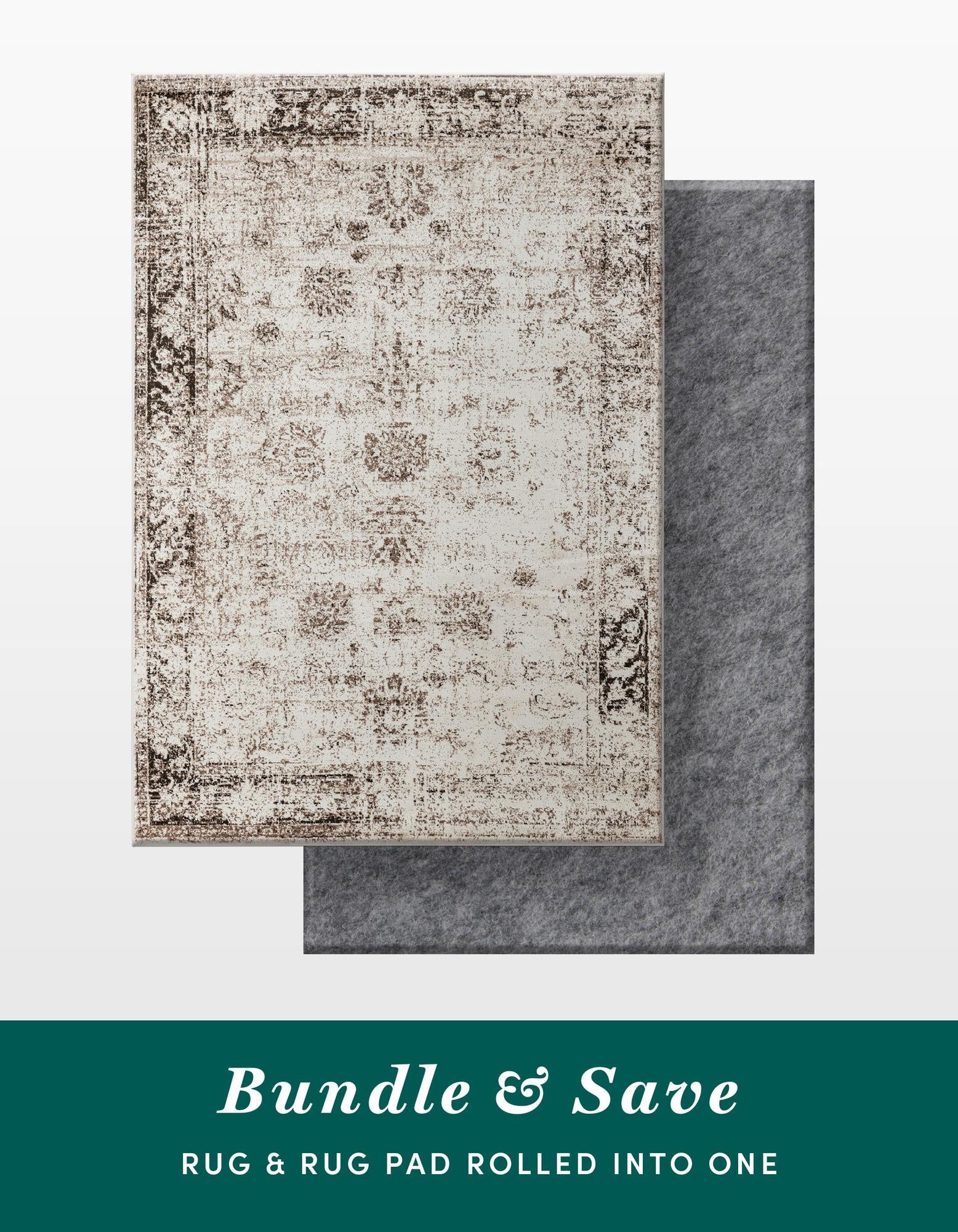 A 6x9 rectangular Monte Carlo rug in distressed brown and ivory, featuring a vintage traditional pattern, shown atop a gray rug pad.