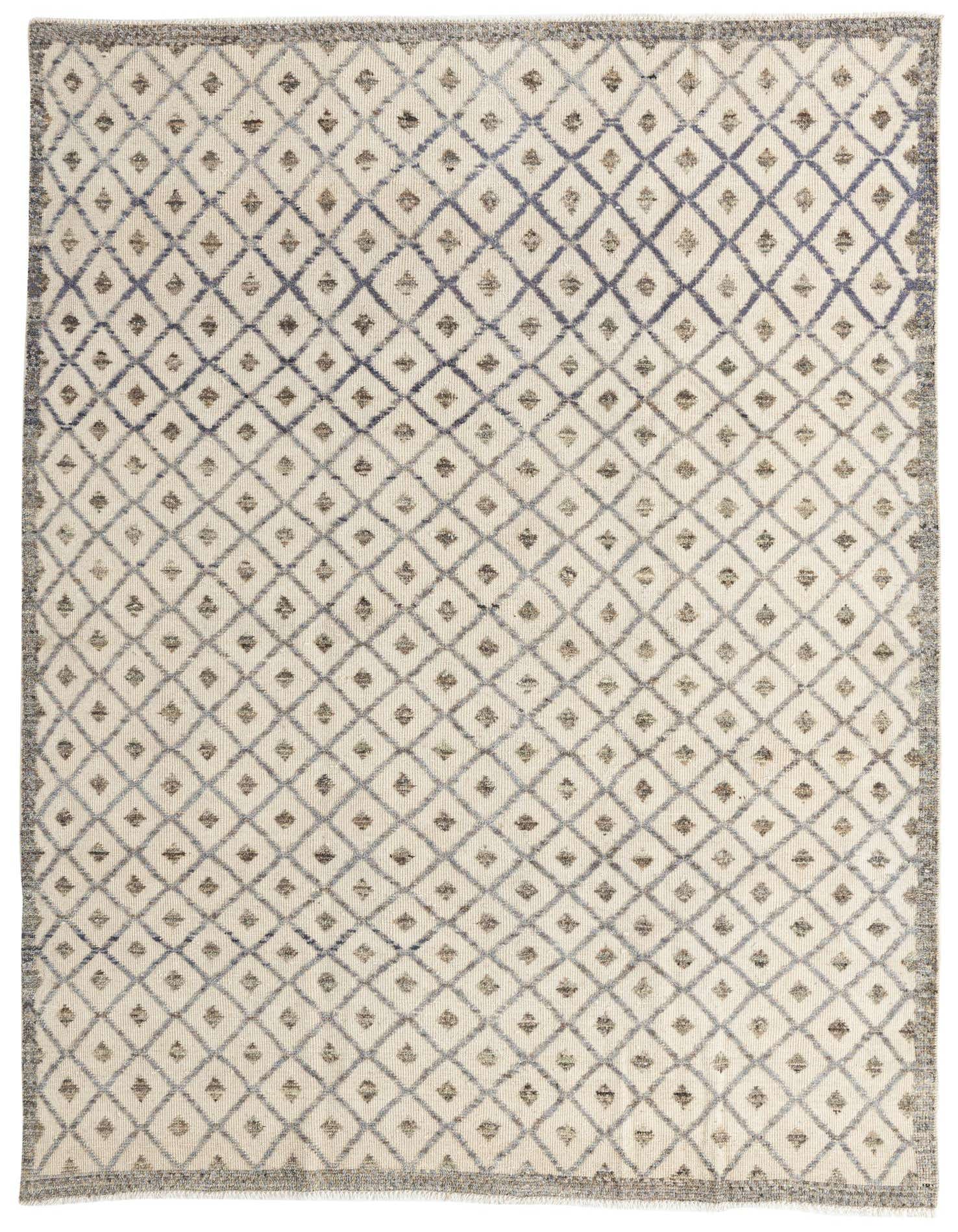 An 8x11 rectangular shag rug featuring a tribal diamond pattern in brown, tan, and cream tones, perfect for a living room.