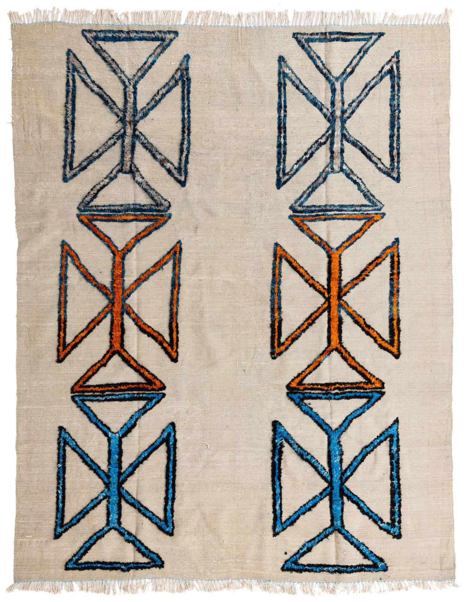 An 8x11 rectangular shag rug with a cream background and a tribal pattern of blue and orange abstract shapes.