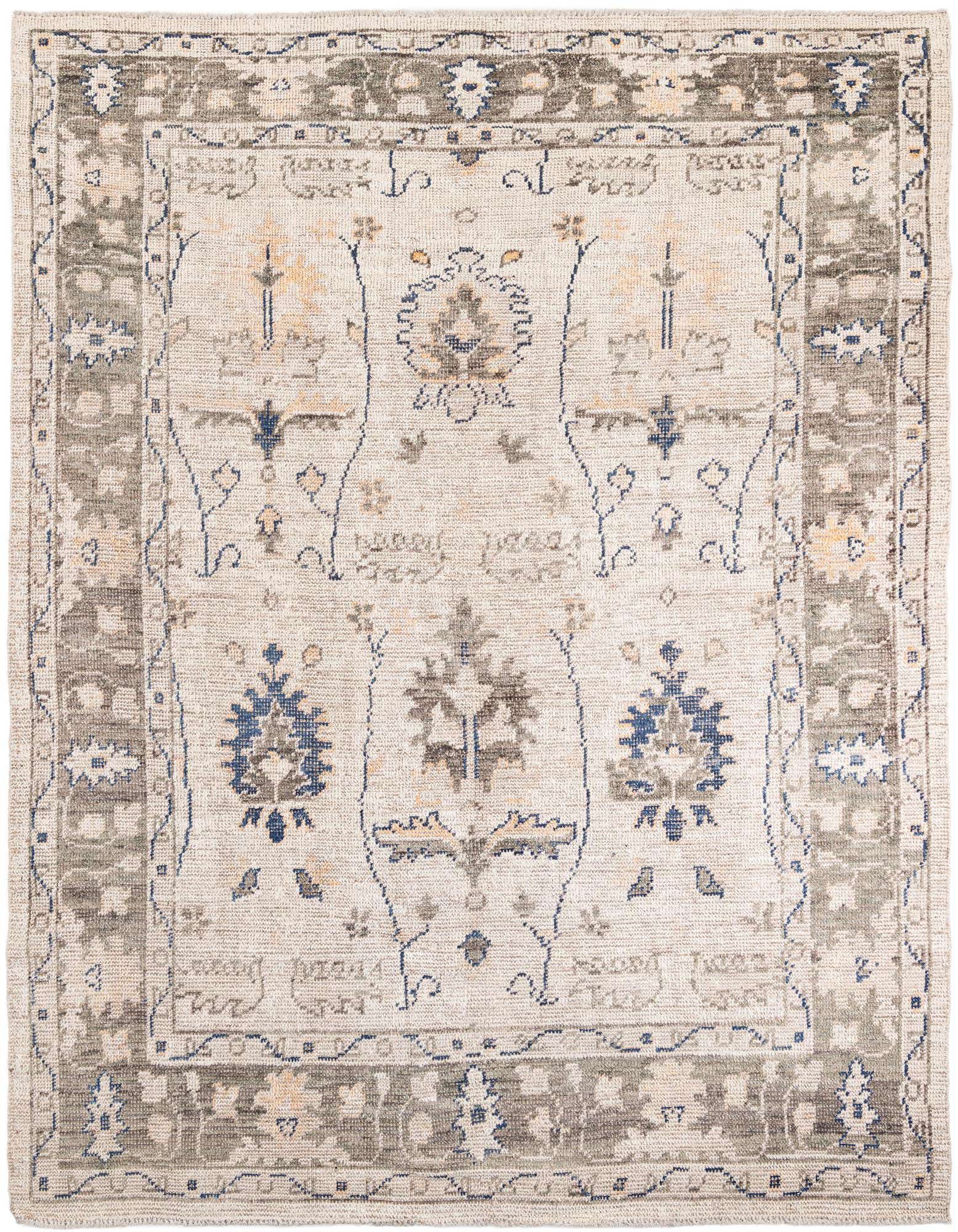 An 8x11 rectangular Moroccan shag rug with a tribal pattern in browns, tans, ivories, and creams, perfect for a living room.