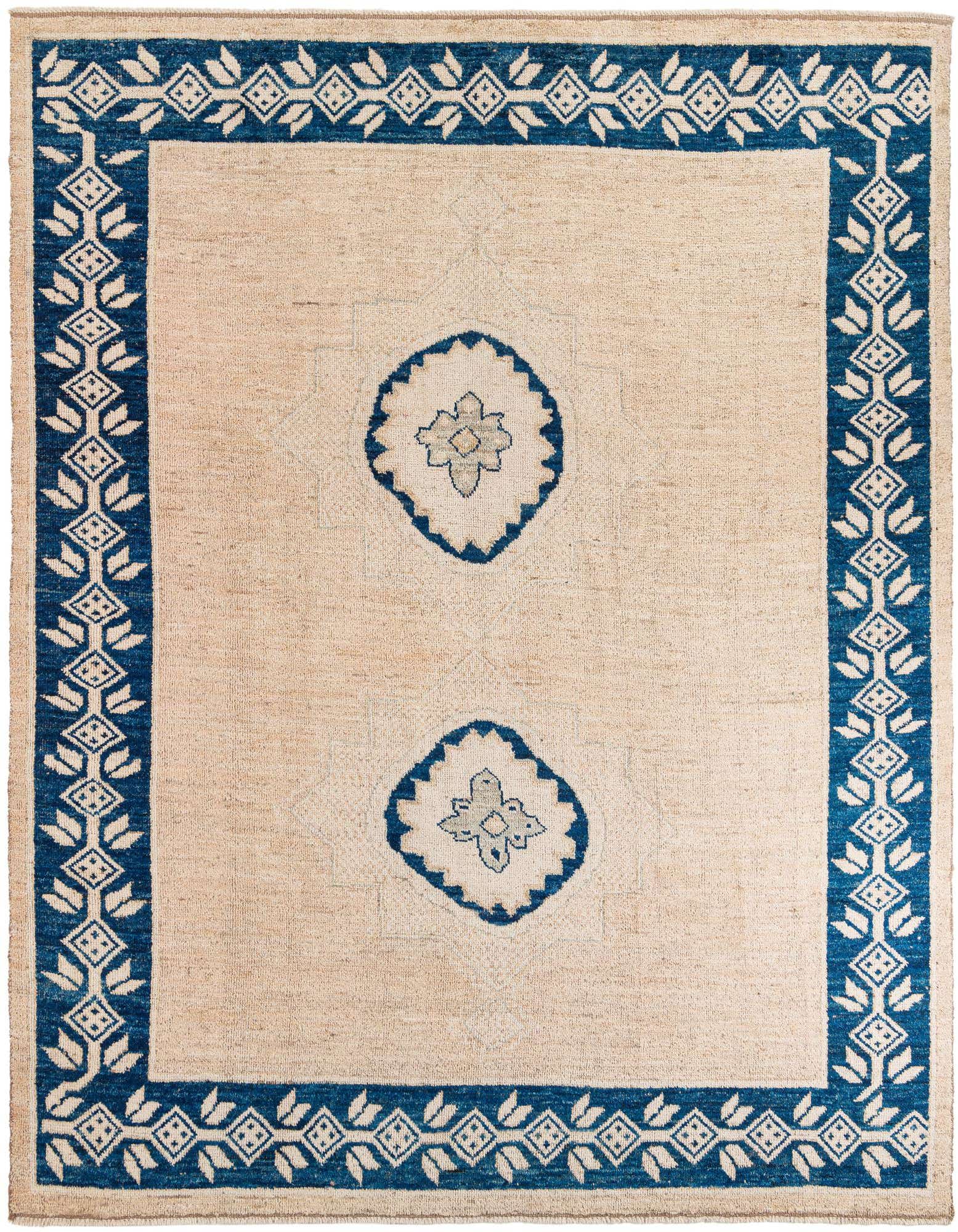A 9x12 rectangular Moroccan wool shag rug in brown and ivory with a tribal medallion pattern and a bold blue border.
