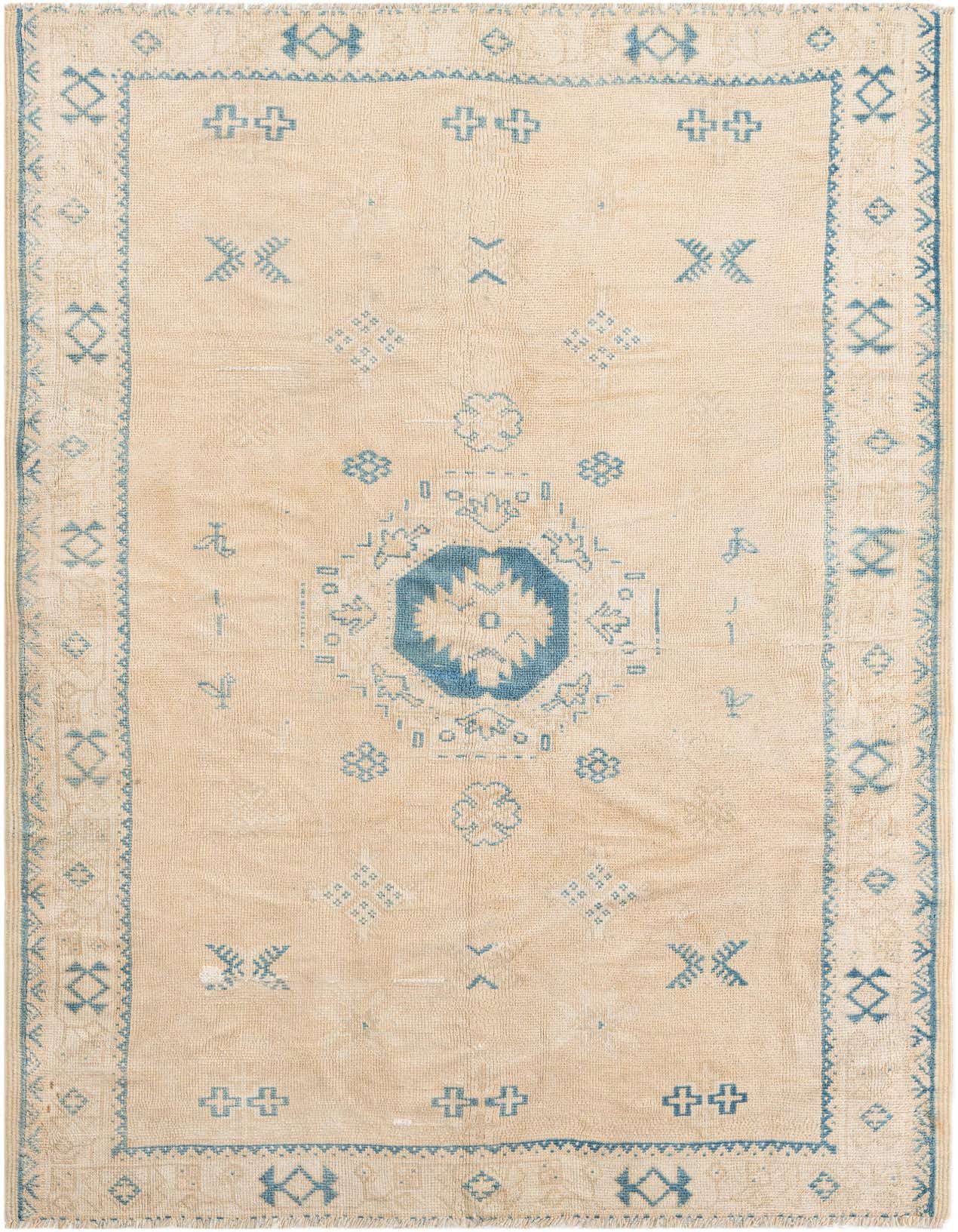 A 5x8 rectangular Moroccan shag rug in cream and light blue, featuring a central medallion and tribal patterns.