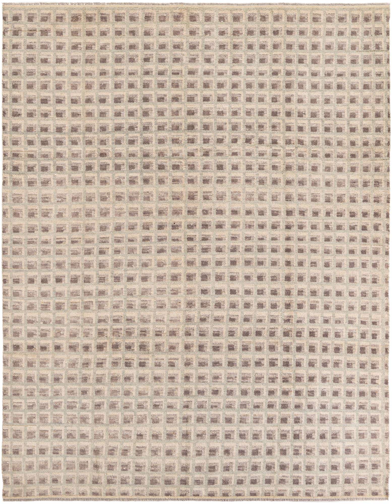 An 8x10 rectangular shag rug with a modern tribal pattern in shades of brown, tan, and cream.