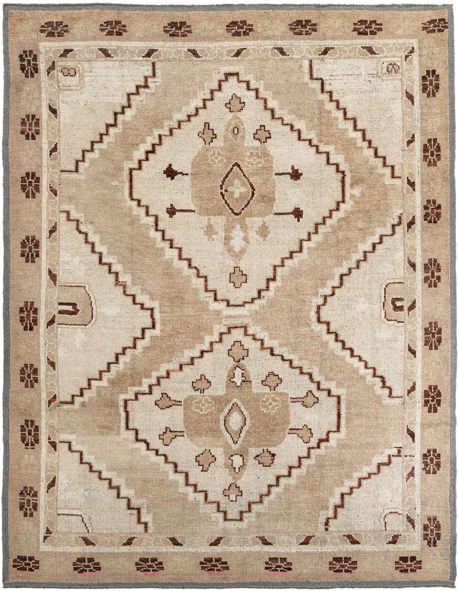 A 9x12 rectangular Moroccan wool rug in brown and ivory with a tribal medallion pattern, suitable for a living room.