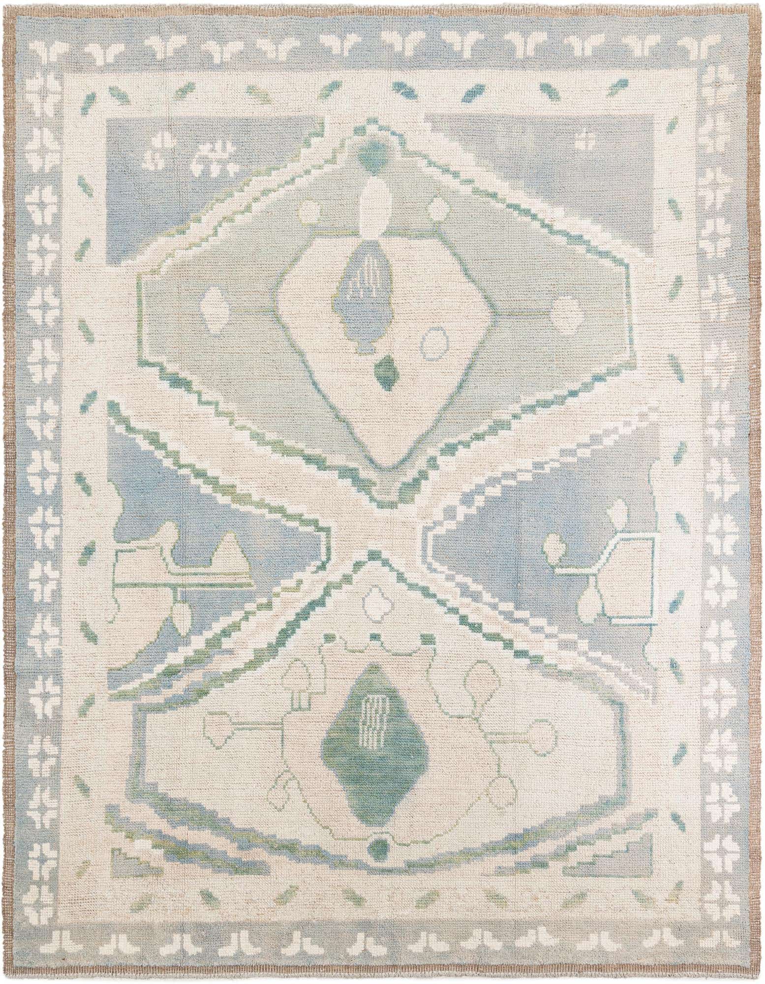 An 8x10 rectangular Moroccan shag rug in ivory, cream, and light blue with a tribal medallion pattern.