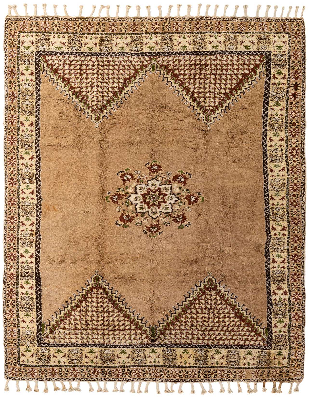 A rectangular 8x12 Moroccan shag rug in brown and ivory with a central medallion and tribal patterns.