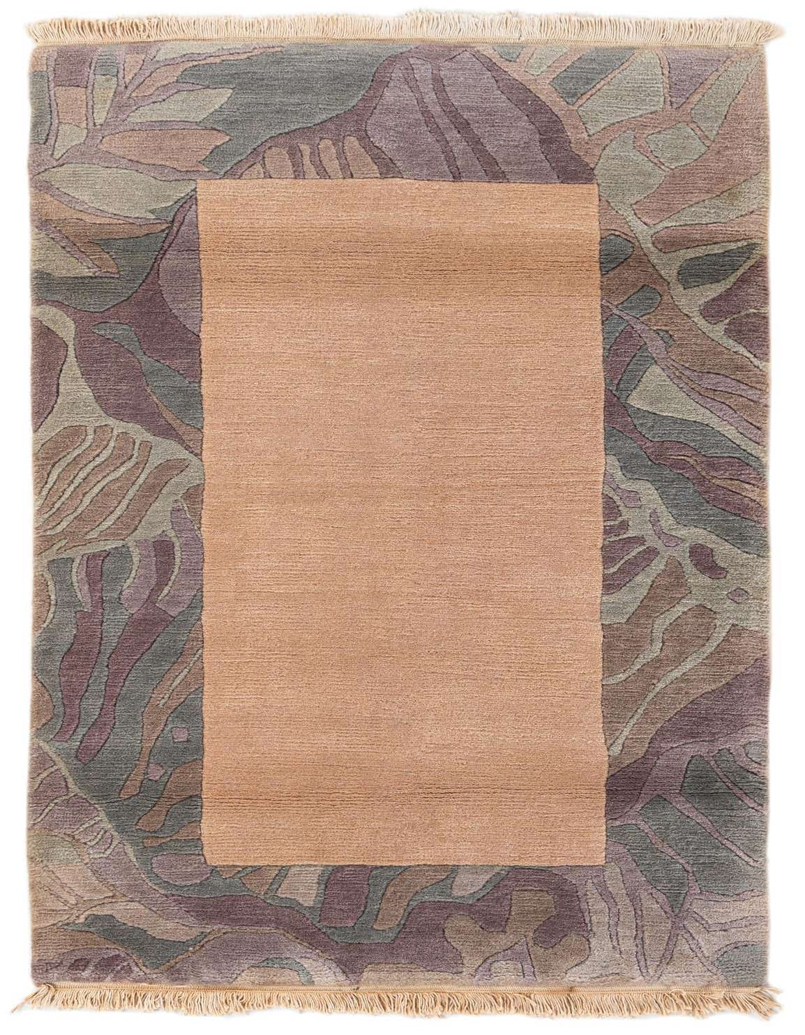 A 3x5 rectangular wool rug featuring a solid tan center bordered by an abstract pattern in shades of brown, cream, and muted green, with fringe.