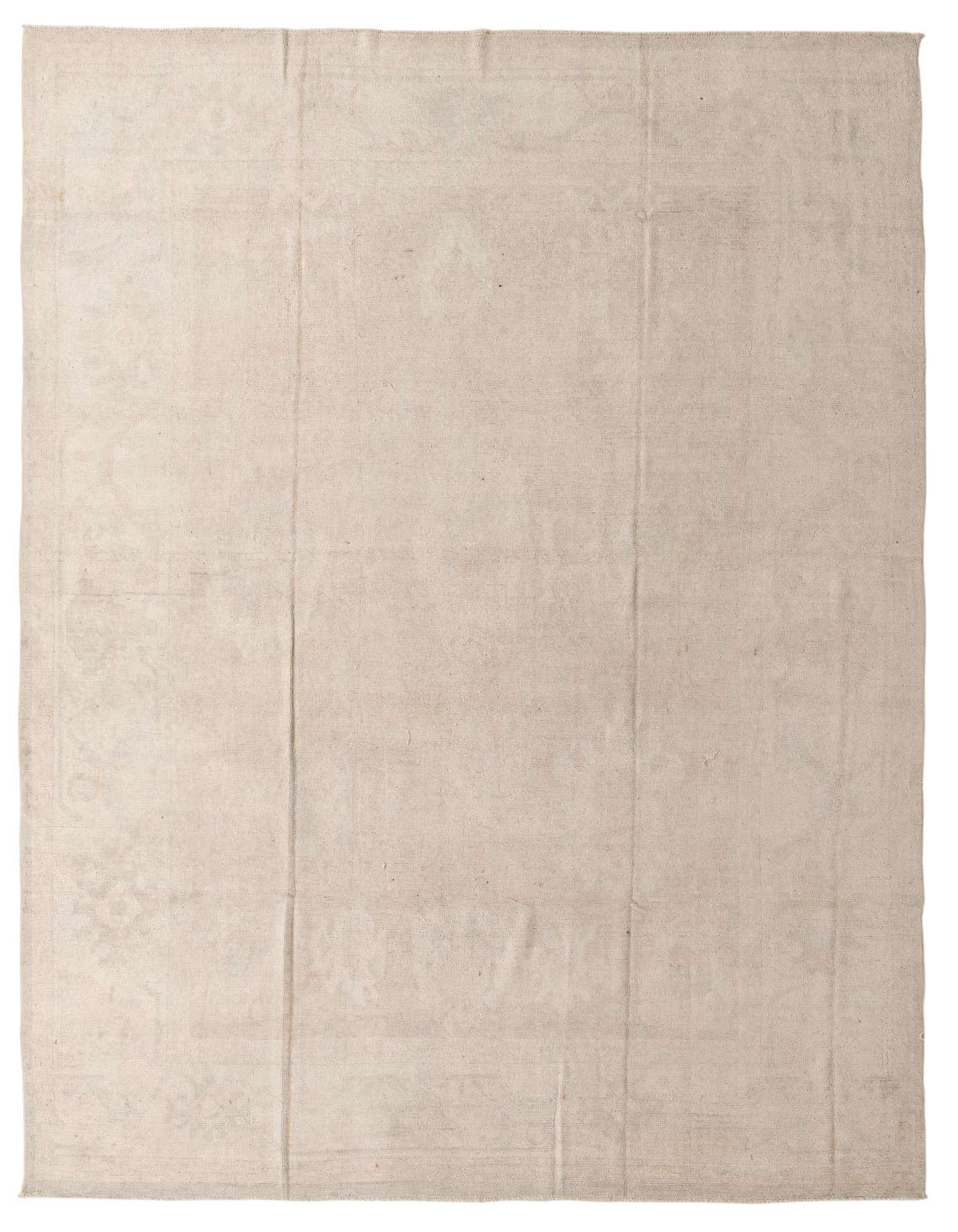 A 10x13 rectangular Oushak rug in shades of brown and cream, featuring a subtle country pattern.