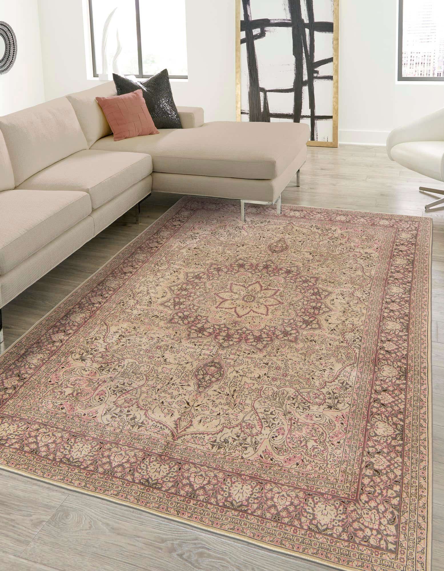 An 8x12 rectangular Ultra Vintage wool rug in browns, tans, and creams with a traditional Persian medallion pattern, placed under a sectional sofa in a modern living room.