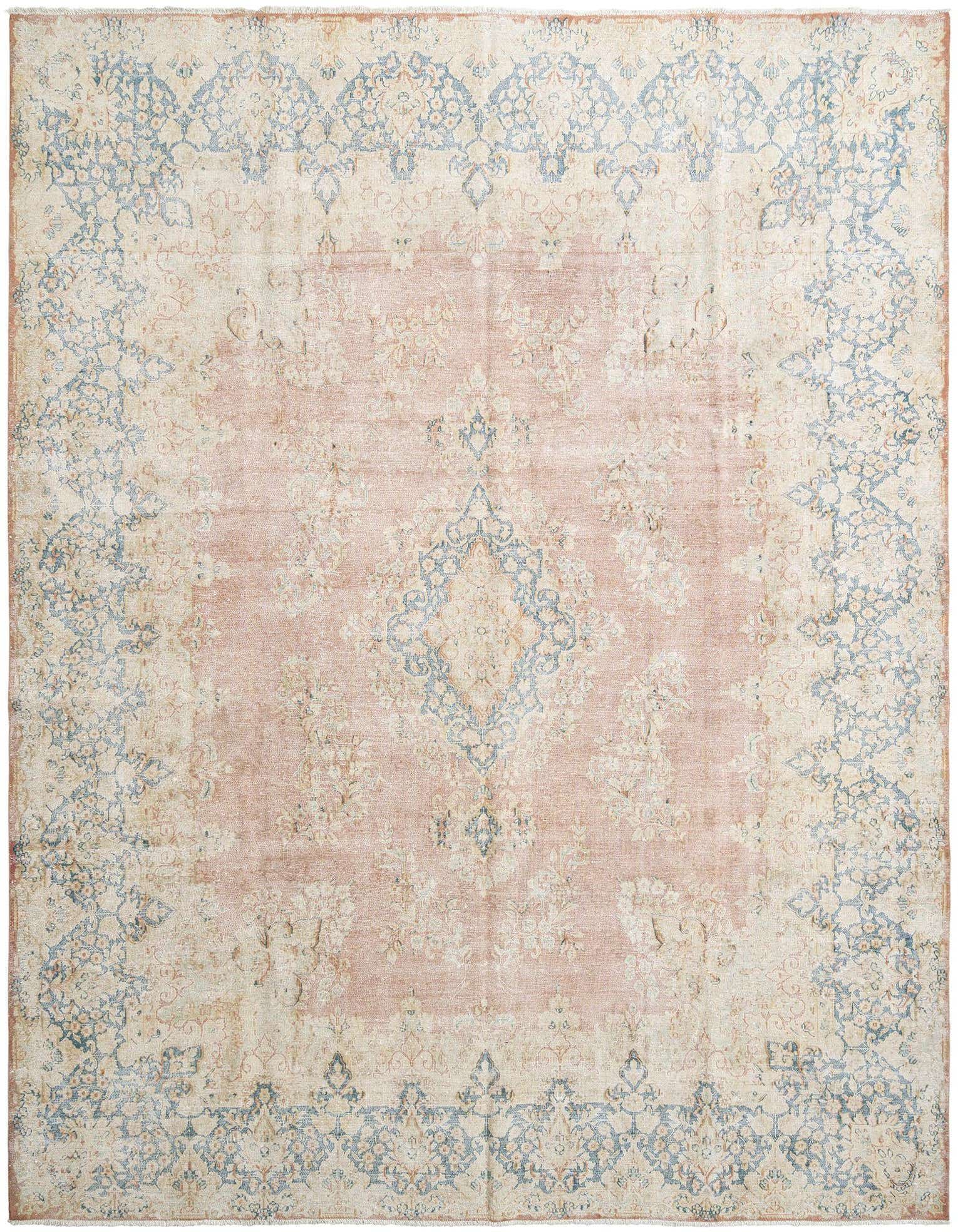 A 10x13 rectangular Persian rug with a faded look, featuring a central medallion in muted pink and ivory, surrounded by intricate floral patterns in light blue and cream.