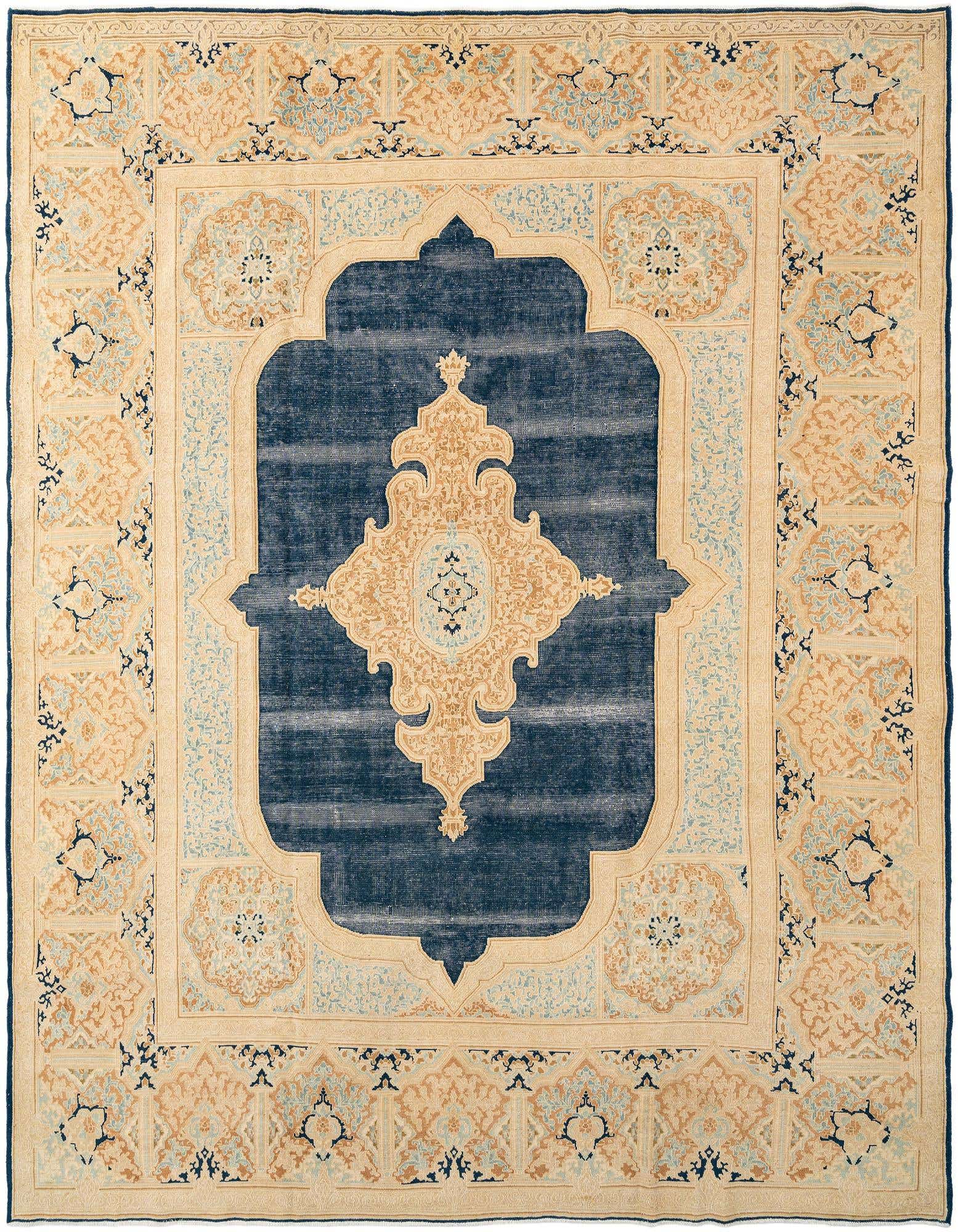 A large 9x12 rectangular wool rug featuring a distressed blue-gray center medallion framed by an ornate ivory and tan border.