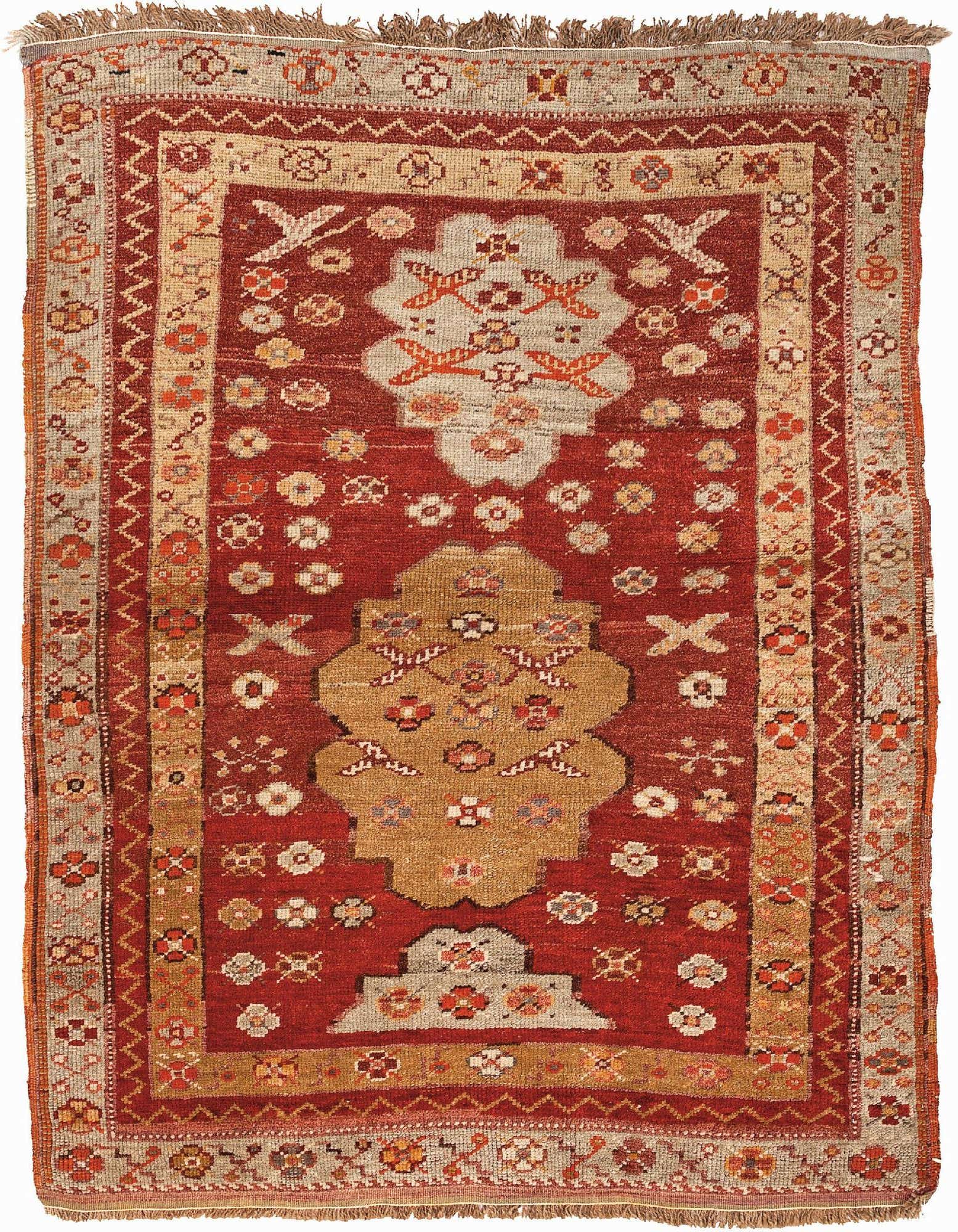 A 3x5 rectangular Yuruk rug featuring a rich red field with geometric patterns in brown, tan, and ivory, and fringed ends.
