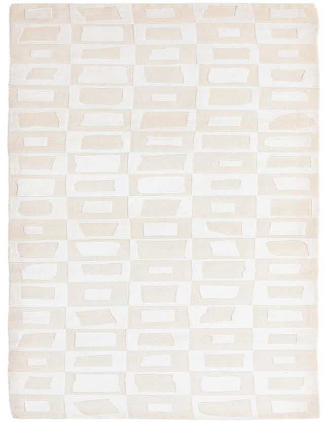 A 10 ft runner rug in shades of brown and ivory, featuring a modern geometric pattern of irregular rectangles.