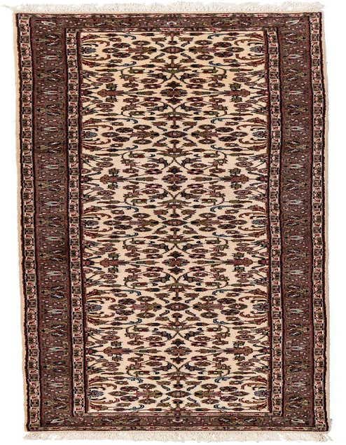An 11 ft runner rug featuring a cream field with intricate floral motifs in brown, red, and blue, bordered by a rich brown frame, ideal for a hallway.