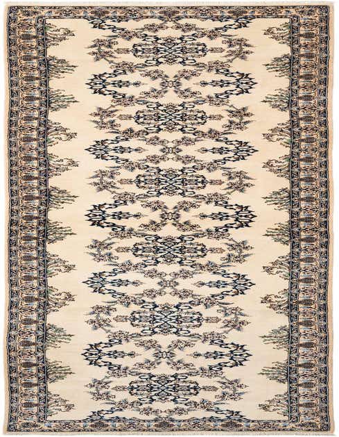 An 11 ft handmade wool runner rug in cream with a traditional floral pattern in brown, tan, and ivory, perfect for a hallway.