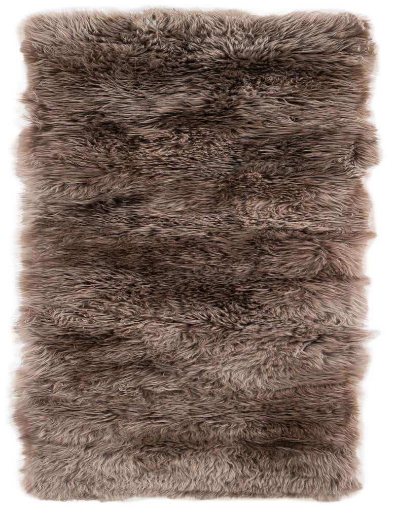A luxurious 6 ft brown lambskin runner rug with a medium, textured pile, perfect for a hallway or bedside.