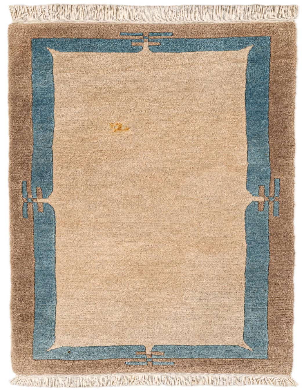 A 5 ft wool runner rug with a cream center, framed by a blue and brown modern abstract border, featuring fringe.