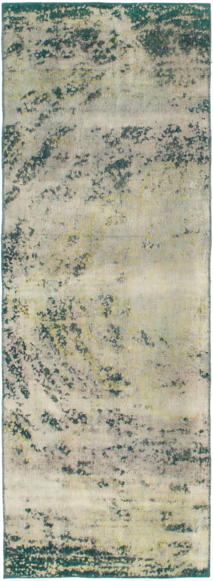 A 9 ft runner rug from the Ultra Vintage collection, featuring an abstract, faded Persian pattern in browns, tans, and creams.