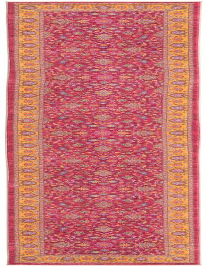 A 13 ft runner rug with a vibrant pink background, featuring a traditional floral pattern and a golden yellow border.