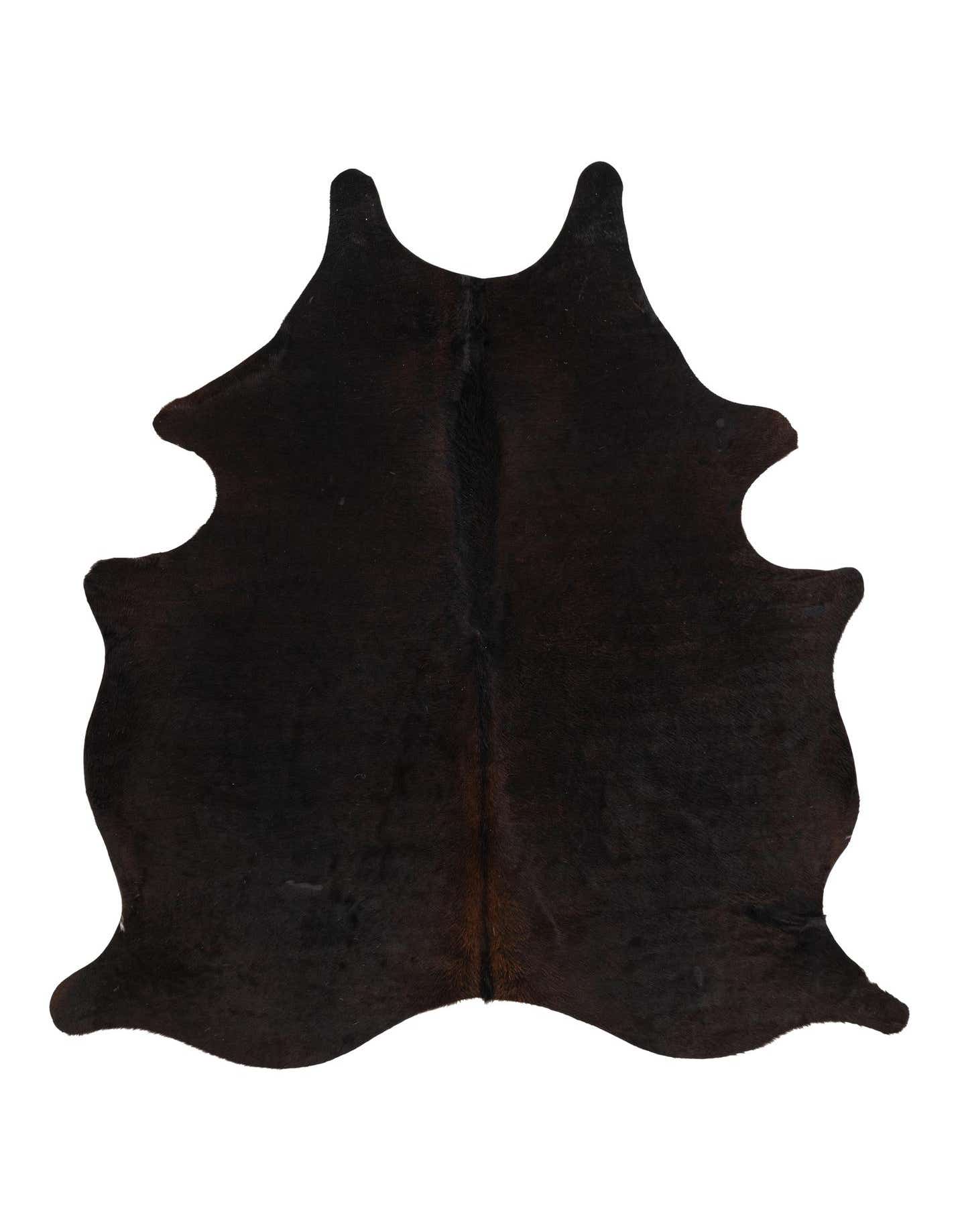 A 5x7 rectangular black cowhide rug with natural, irregular edges, showcasing its flat, textured pile.