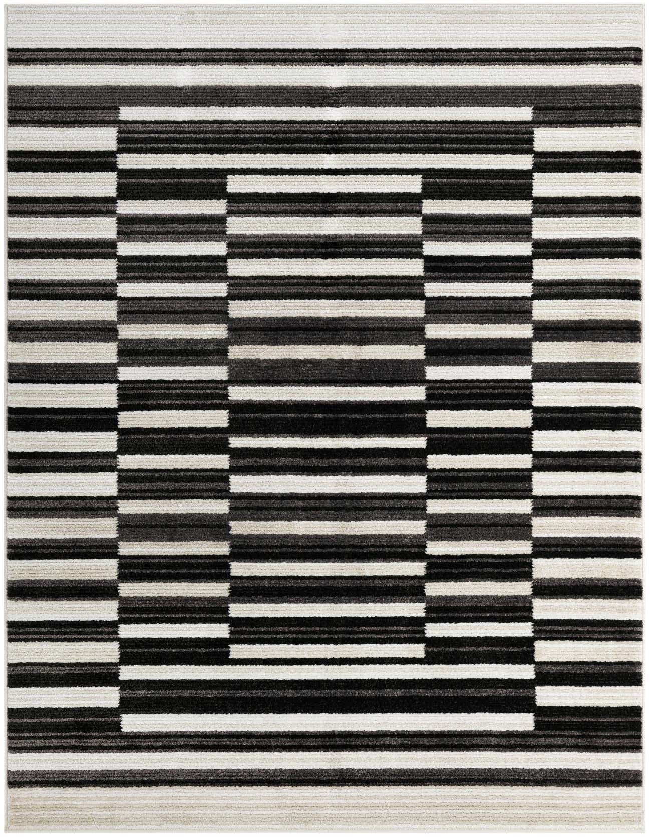 A 6x9 rectangular modern rug featuring a bold geometric stripe pattern in varying shades of black, charcoal, and ivory.