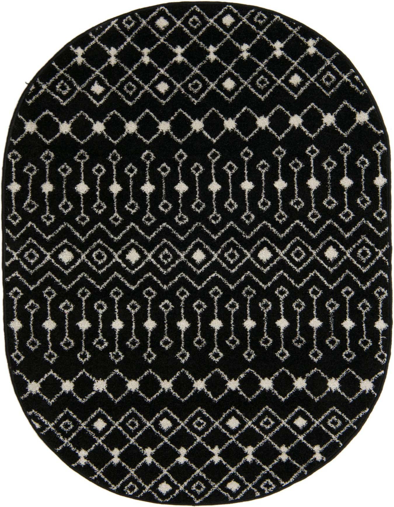 An oval black and ivory Bohemian rug with a tribal trellis pattern, featuring diamonds and zigzags.