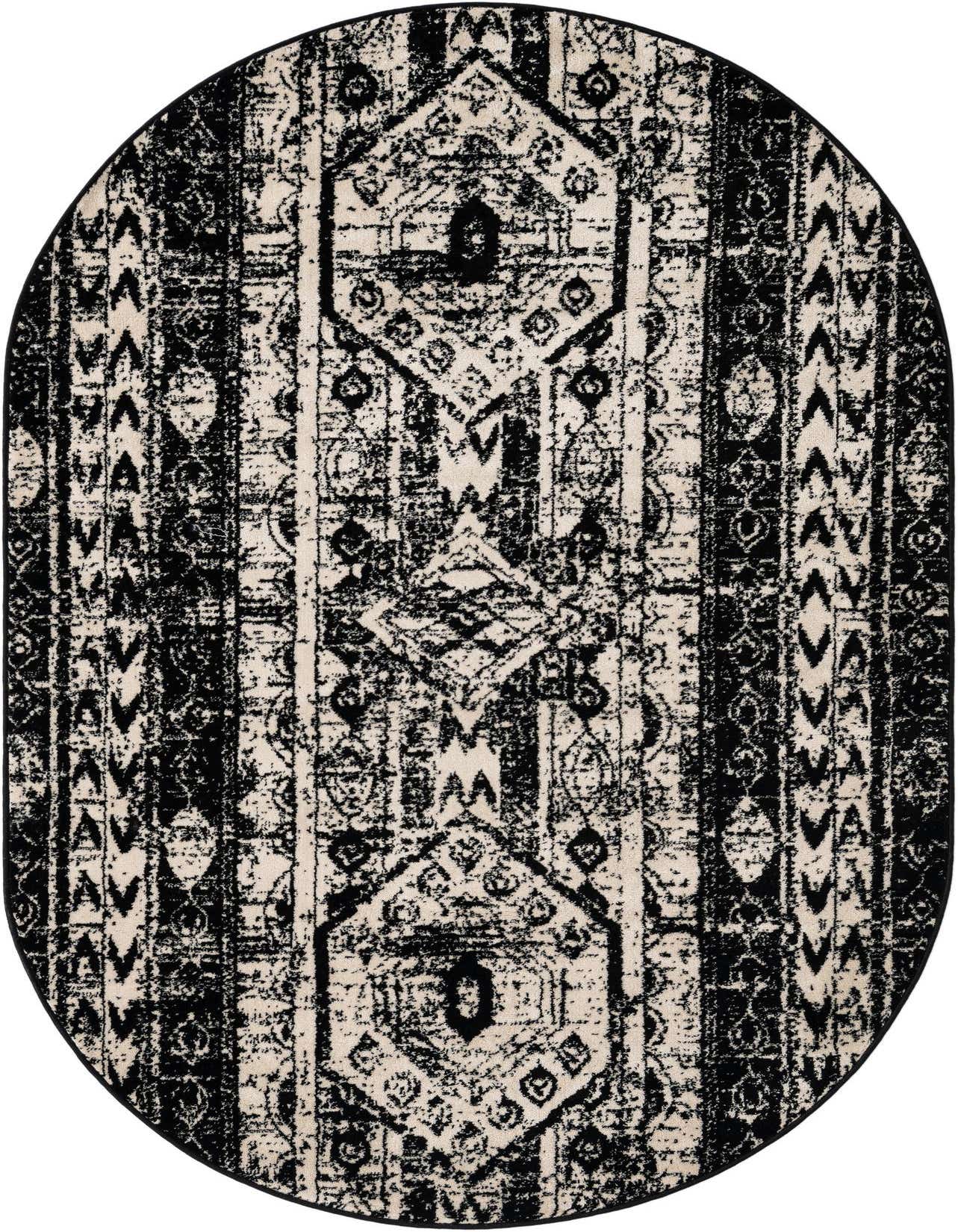 An oval 5'3 x 8'0 black and ivory bohemian rug with a distressed tribal pattern and striped accents.