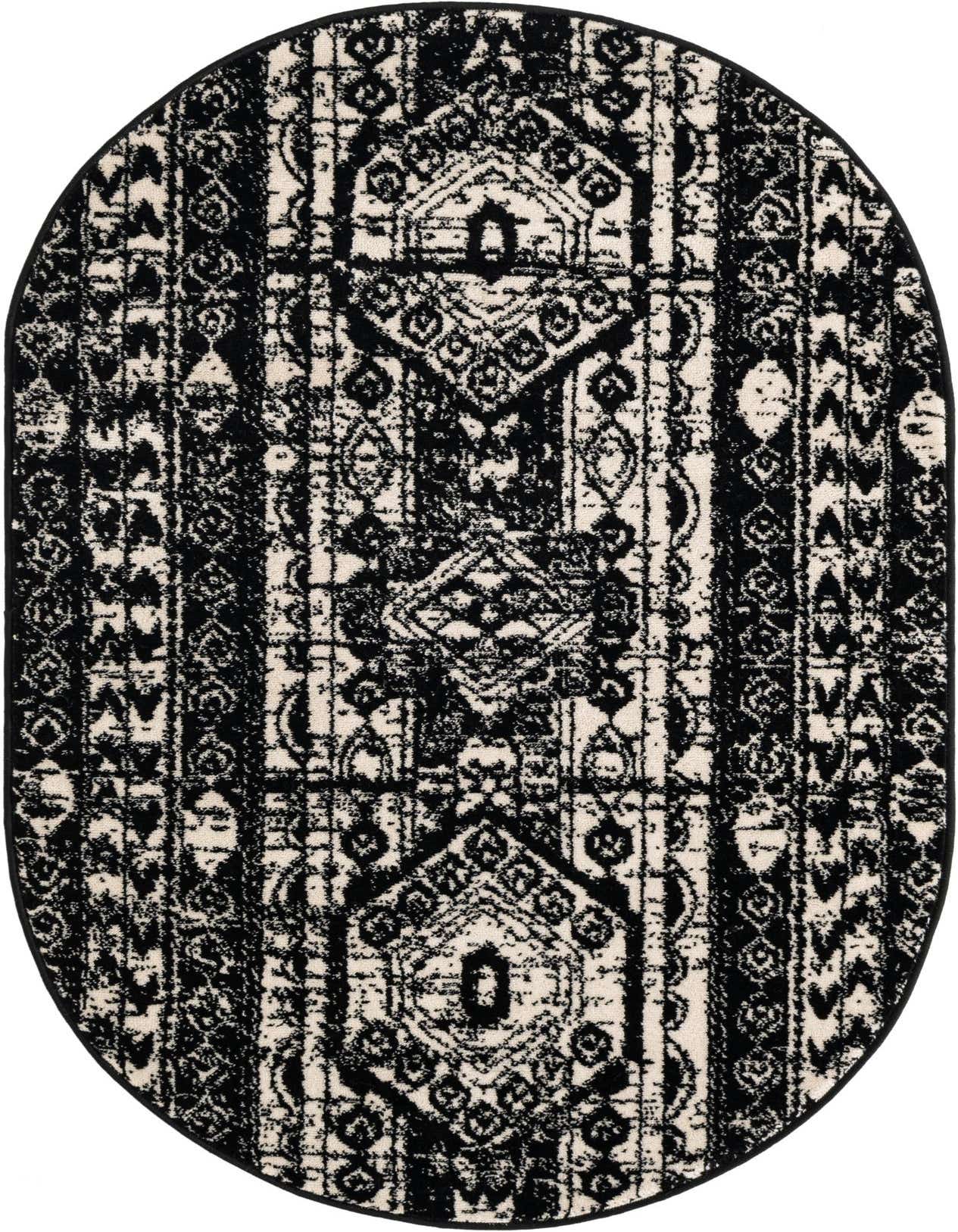 An oval 3' 0 x 5' 3 black and white bohemian rug with a distressed tribal pattern.