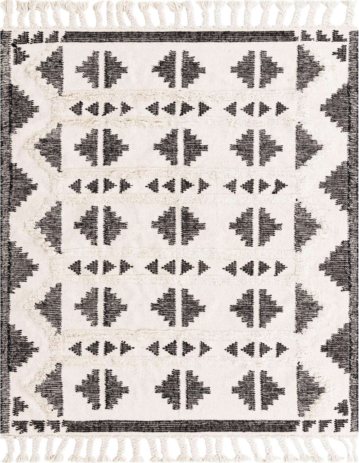 A 5x8 rectangular black and white tribal shag rug with braided tassels, featuring geometric diamond and triangle patterns.