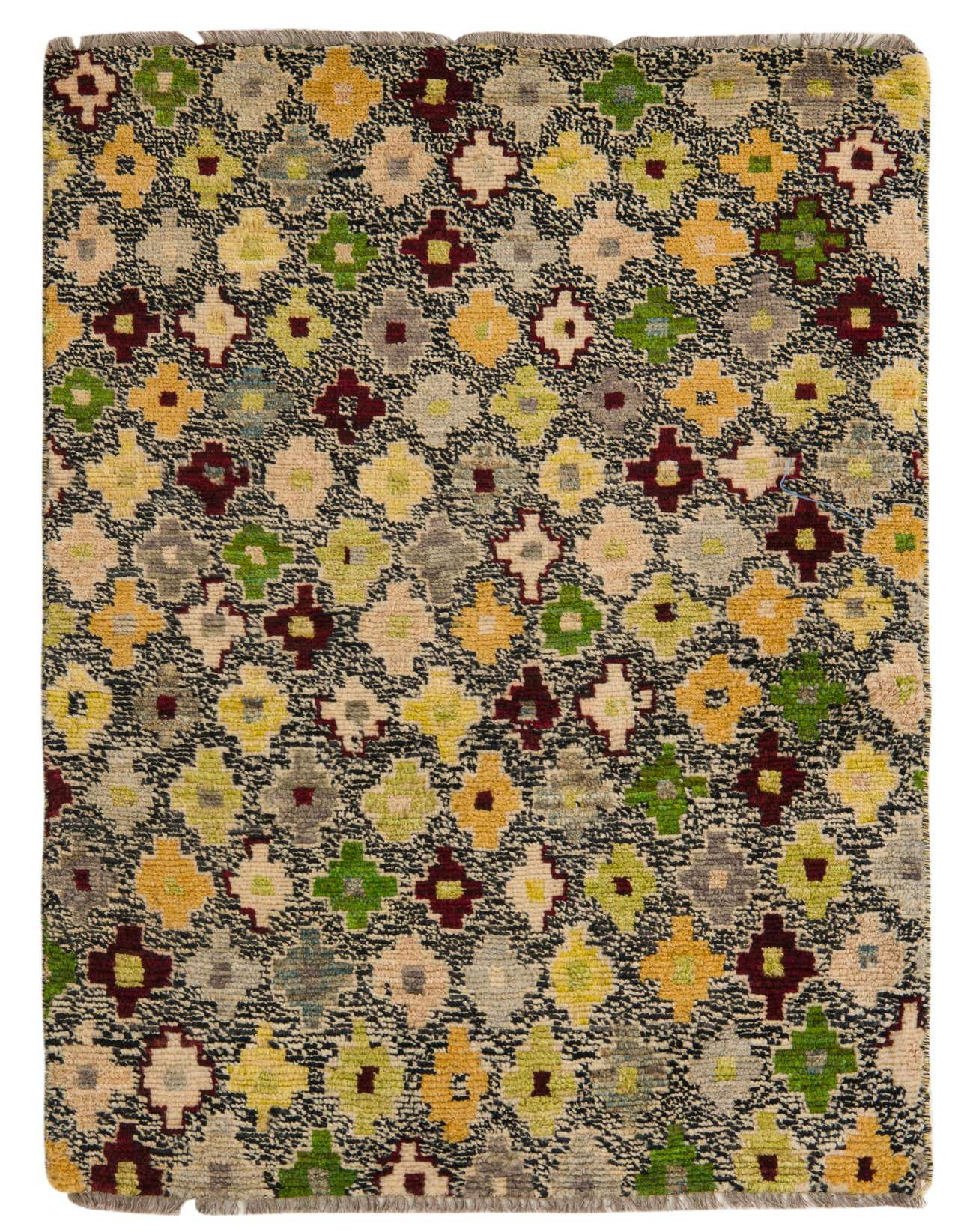 A 3x5 rectangular Balouch rug with a tribal, modern, abstract pattern in black, ivory, green, yellow, and burgundy.