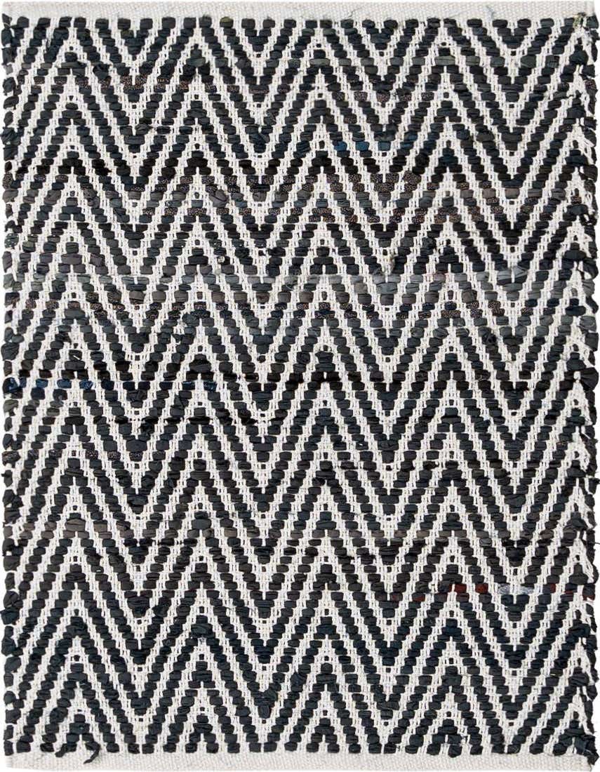 A close-up of a 2x3 rectangular Chindi Chevron rug featuring a bold black and white zigzag pattern made from textured, recycled cotton.