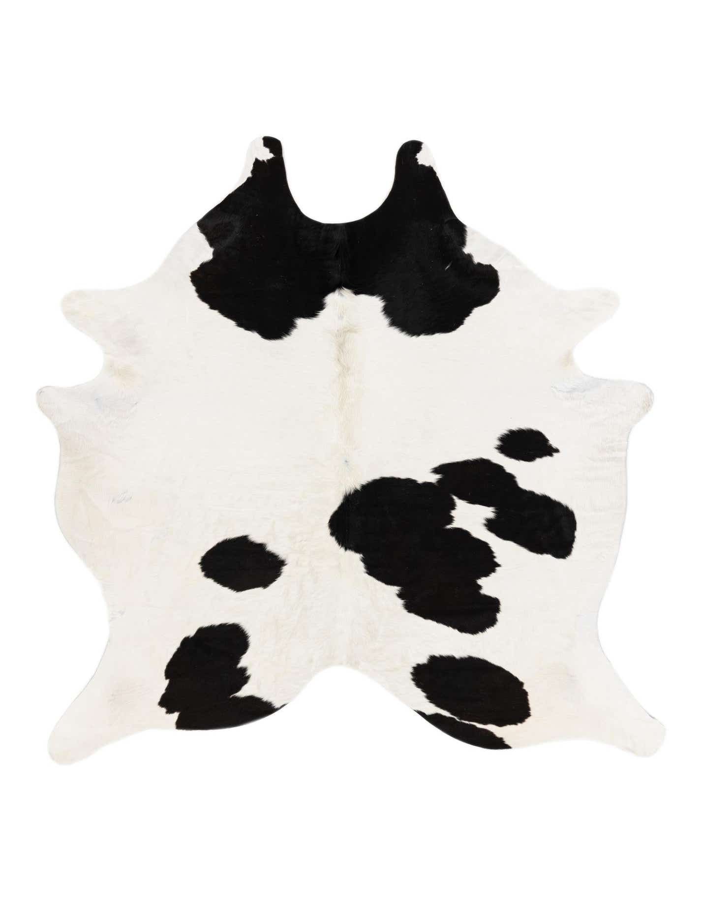 A black and white cowhide rug with an irregular, natural shape, featuring bold black spots on a creamy white background.
