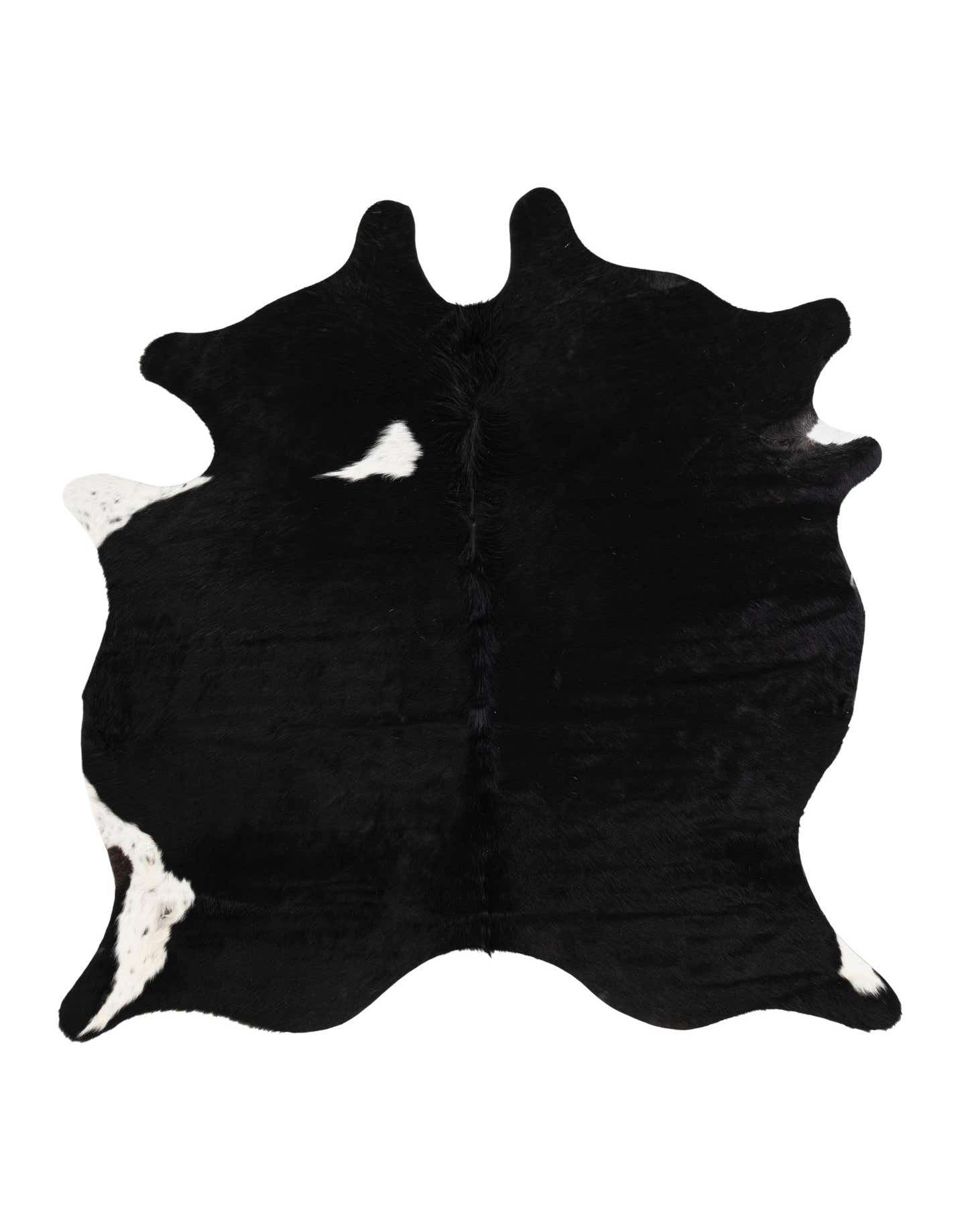 A 5x8 rectangular black and white cowhide rug with an irregular shape, featuring natural black fur with white patches.