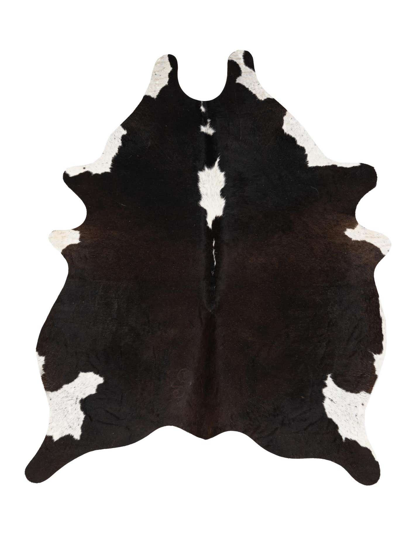 A 4x6 black and white cowhide rug with an irregular, natural shape, featuring a prominent white stripe down the center and white patches along the edges.