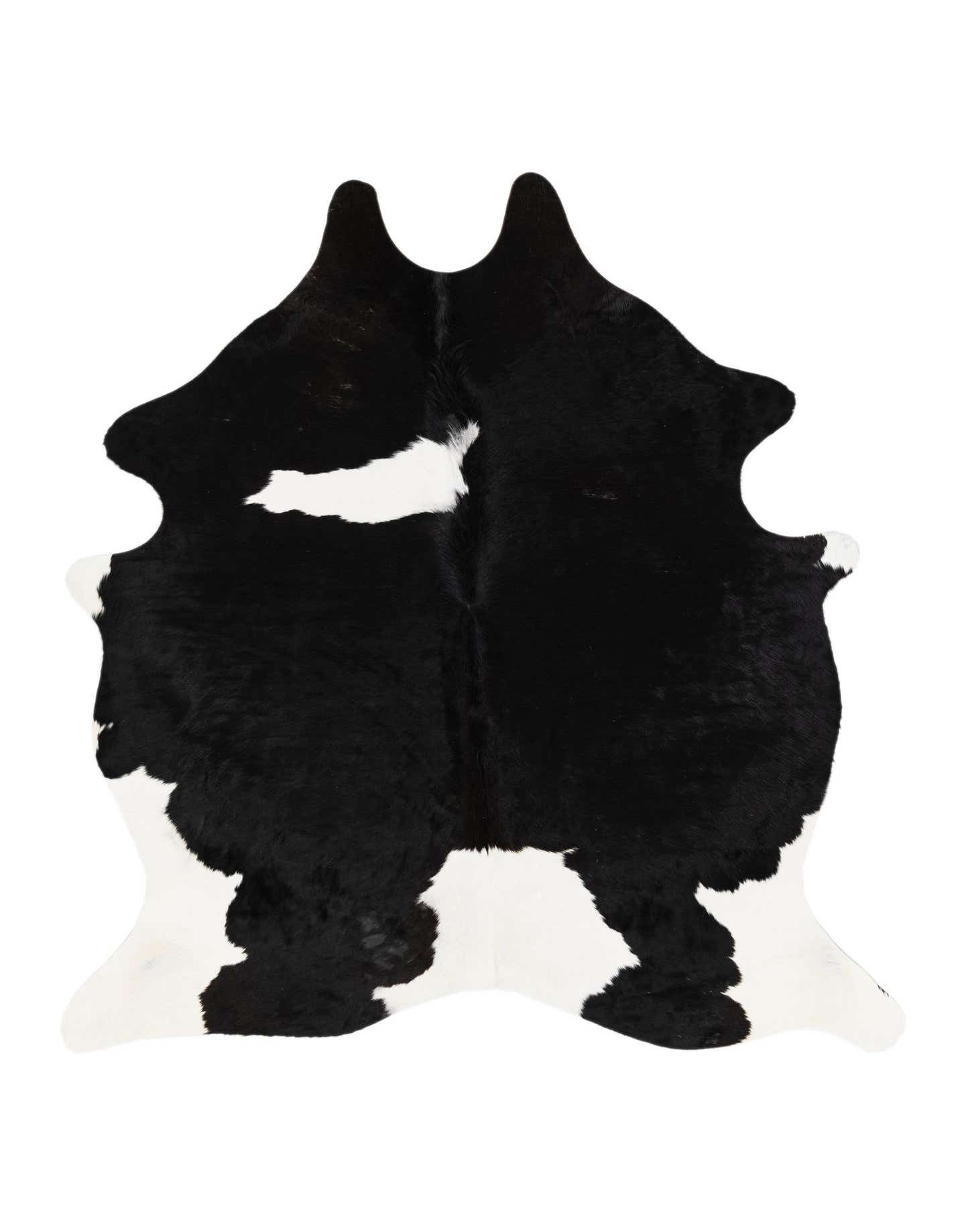 A 5x7 black and white cowhide rug with an irregular shape and natural markings, showcasing its modern, textured appeal.