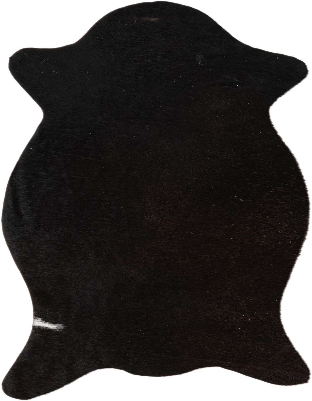 A 2x3 black cowhide rug with a natural, irregular shape and short, flat pile, featuring a small white stripe on one edge.