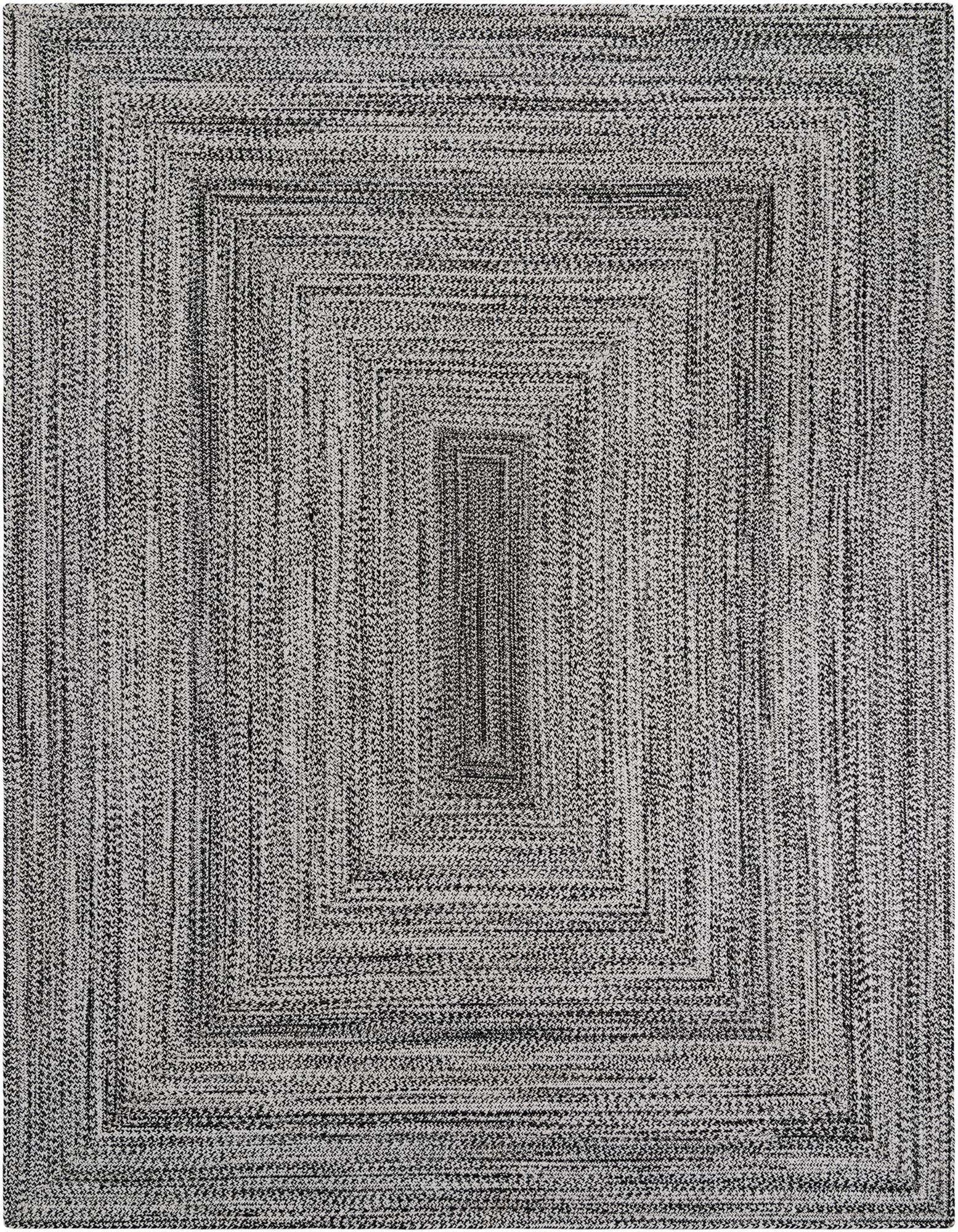 A rectangular 8x10 black and white braided rug with a concentric rectangular pattern, suitable for indoor or outdoor use.