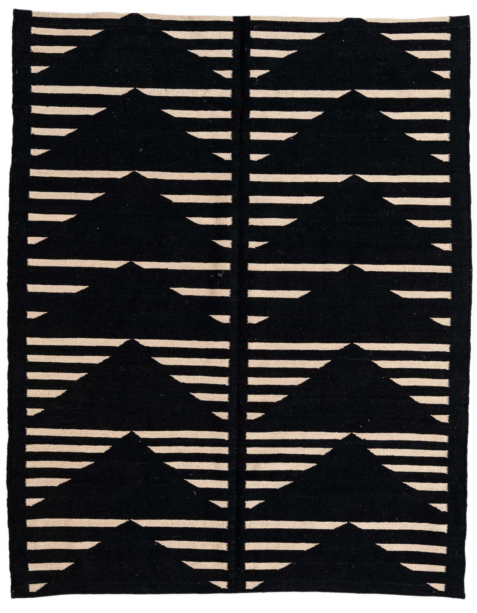 A 5x8 rectangular black and ivory flatweave rug with a modern tribal stripe pattern, featuring rows of black triangles and horizontal ivory lines.