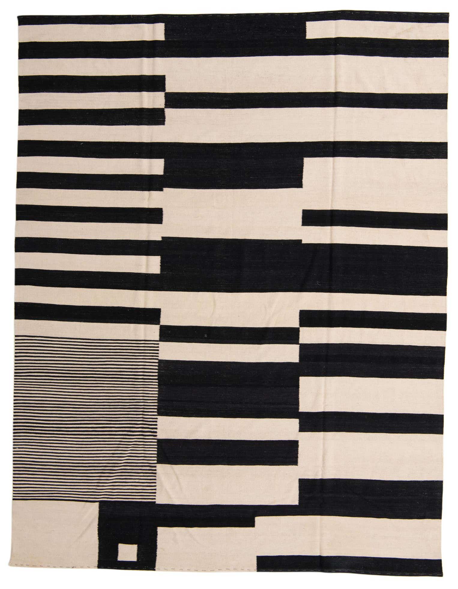 A large 8x11 rectangular Kilim Modern rug with bold black and ivory stripes and geometric patterns.