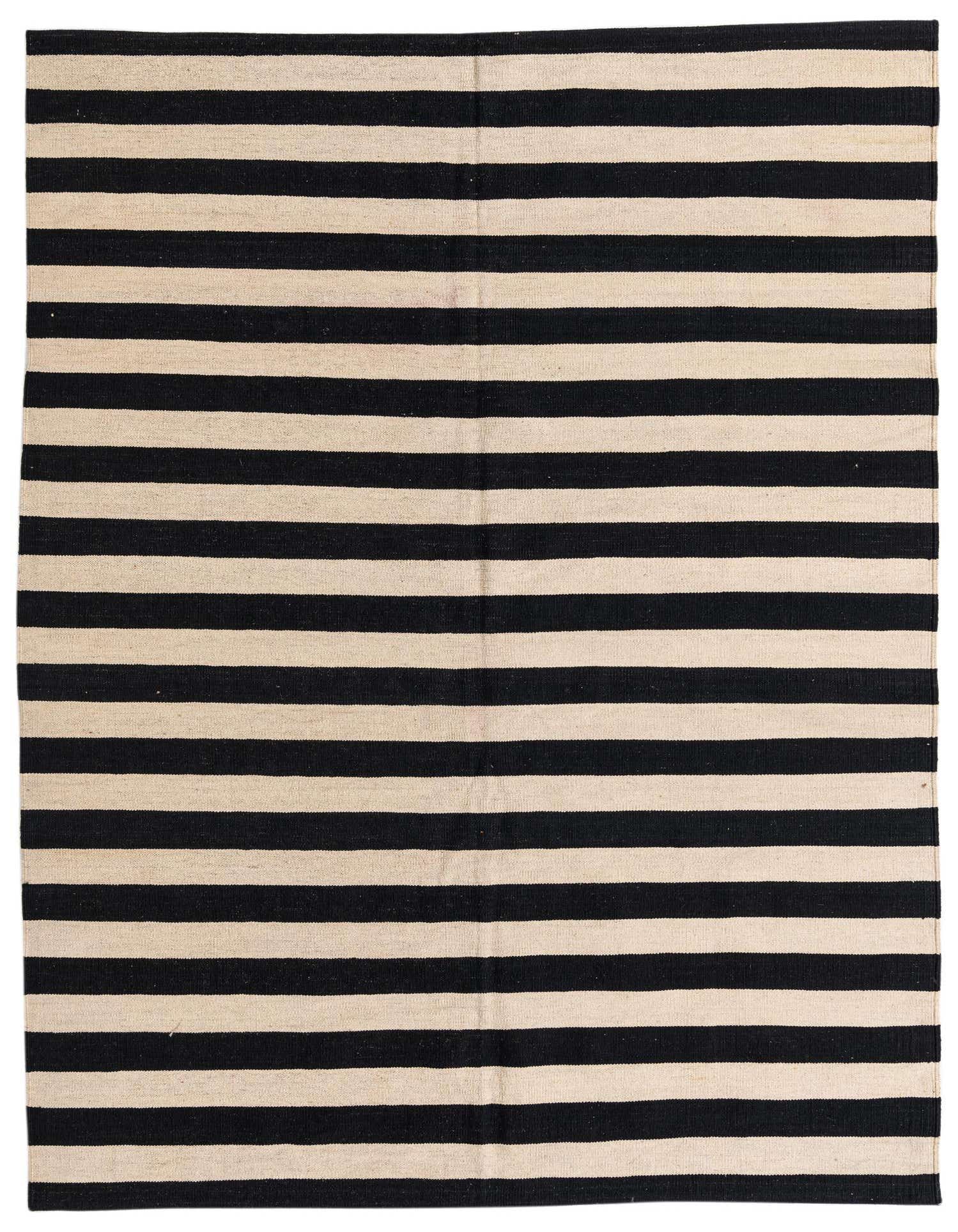 A 5x8 rectangular black and cream striped flatweave rug, handmade from wool, ideal for a modern living room.