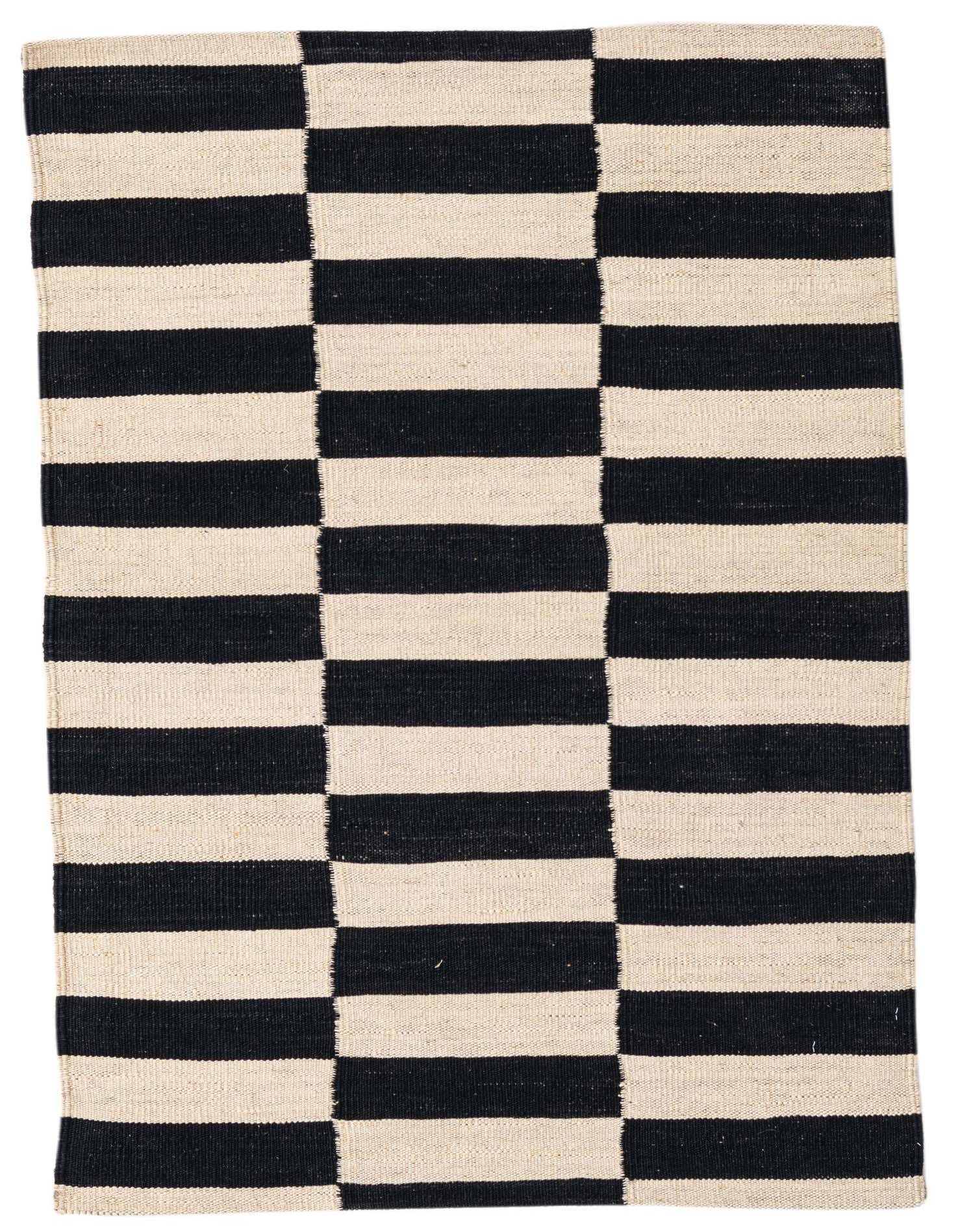 A 3x4 rectangular flatweave rug with a bold black and cream checkerboard pattern, perfect for a modern or tribal indoor space.