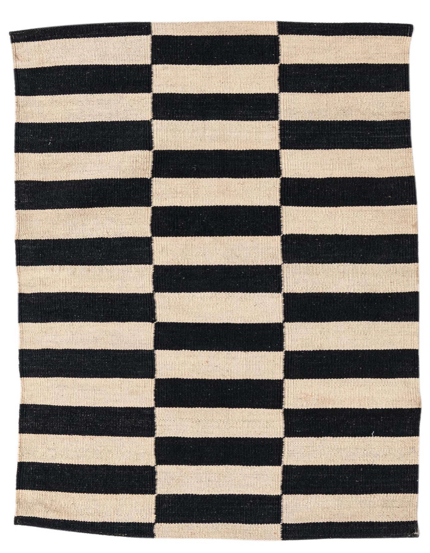 A 3x4 rectangular flatweave rug with a bold black and ivory striped pattern, perfect for a modern living space.