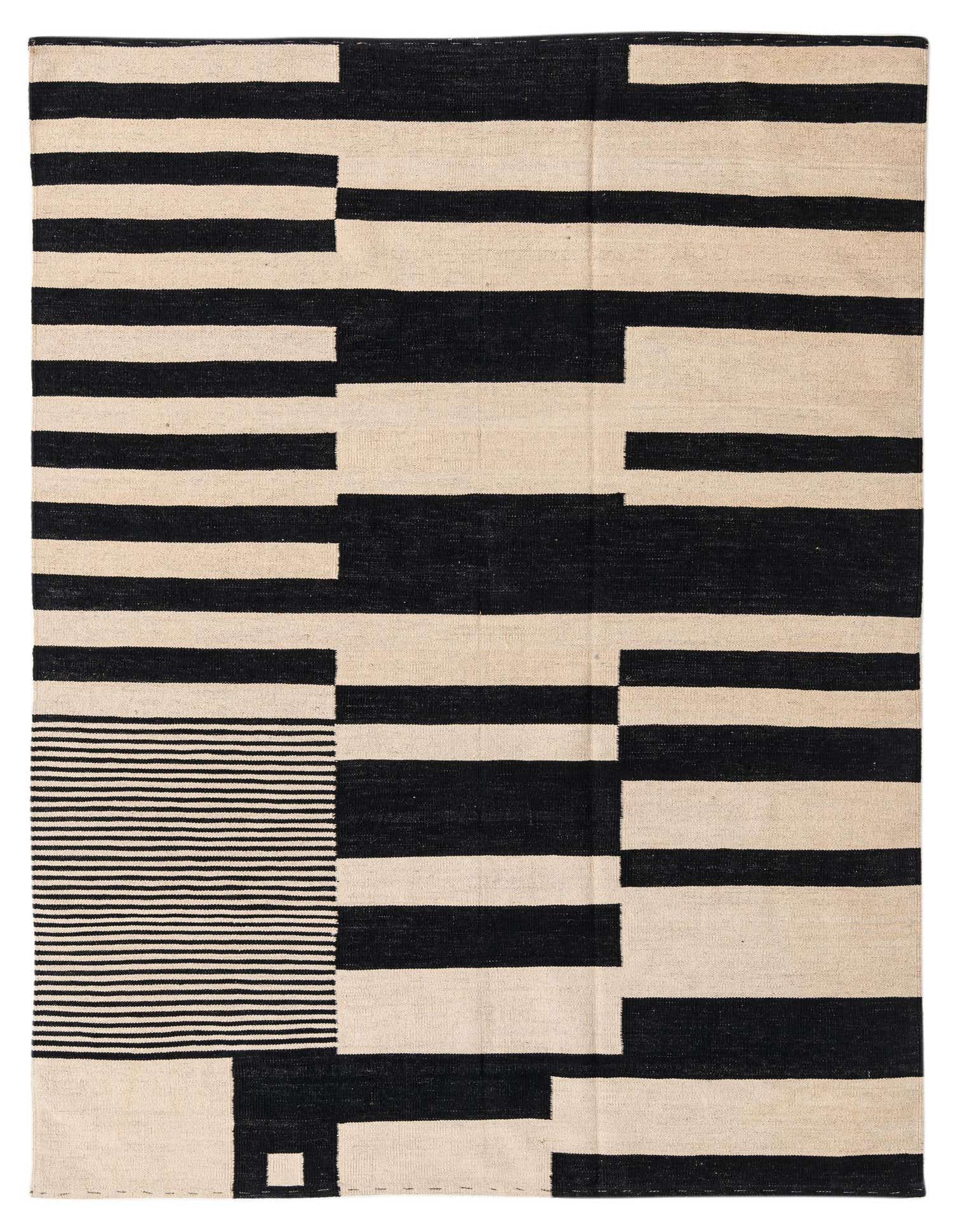 A 5x8 rectangular black and ivory flatweave wool rug with a modern tribal stripe pattern, suitable for a living room.