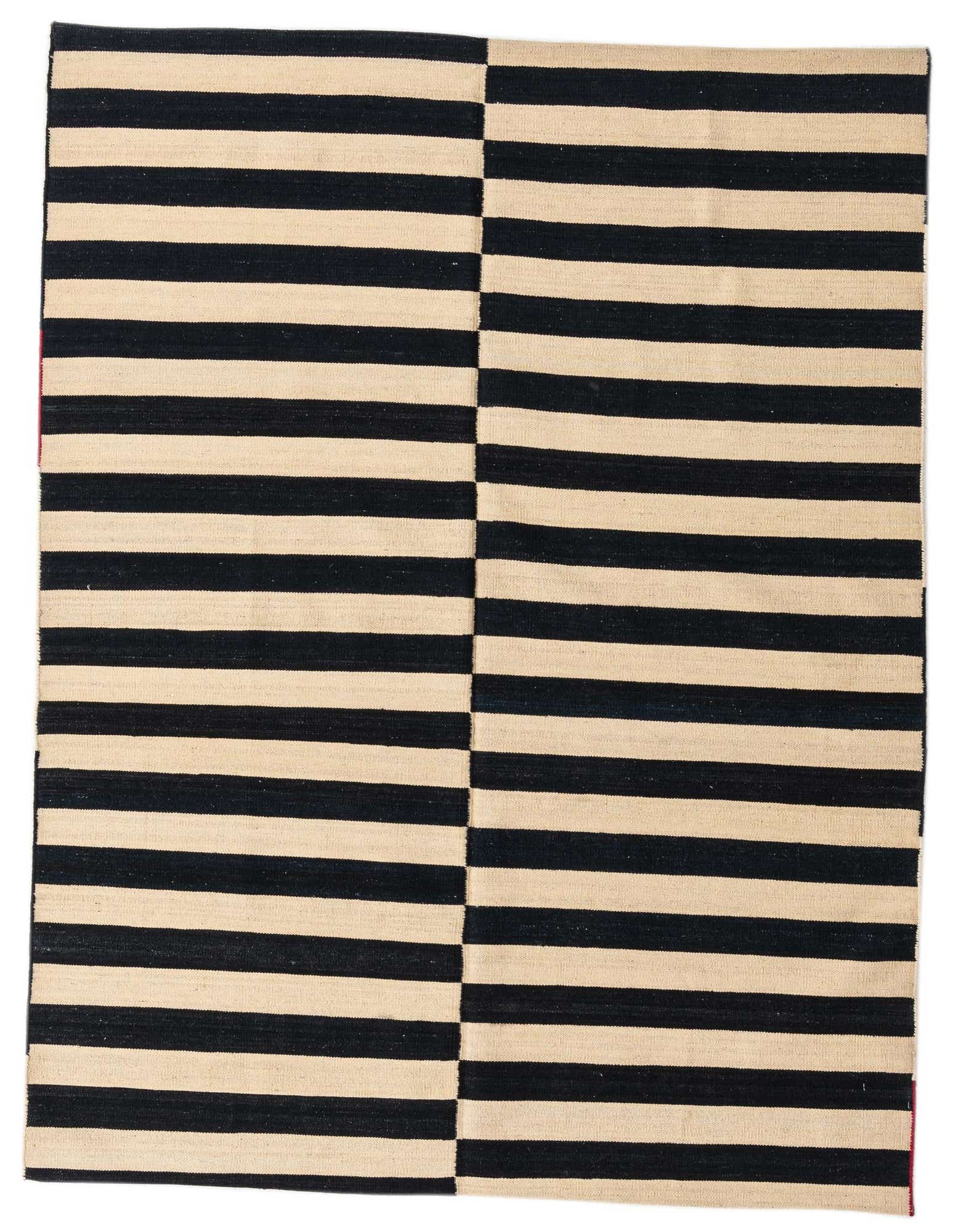 A 5x8 rectangular black and cream striped flatweave rug with a modern tribal pattern, suitable for a living room.